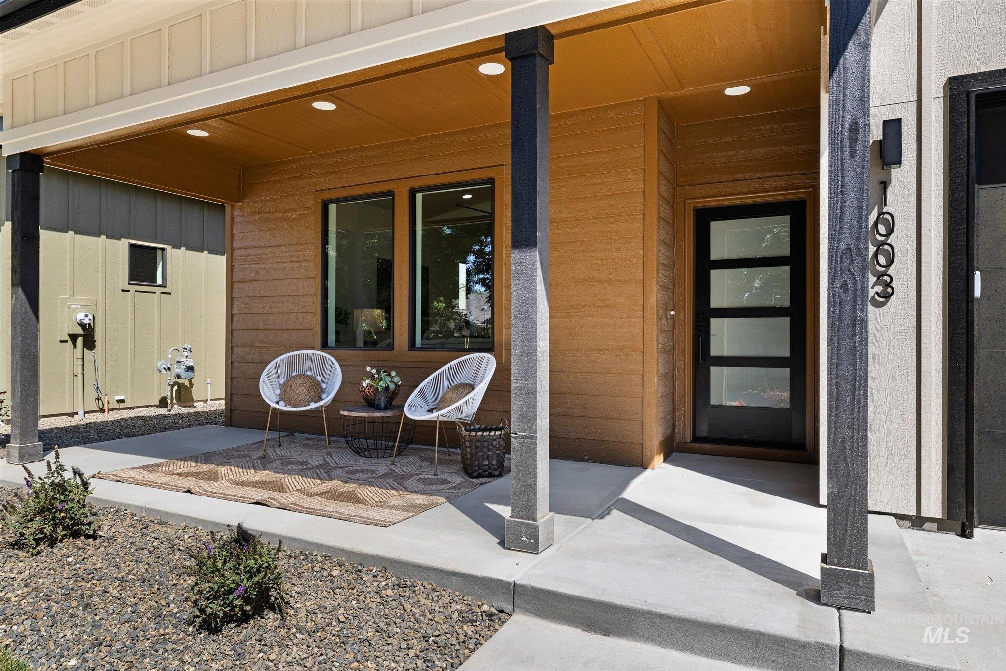 View of exterior entry featuring board and batten siding and a porch