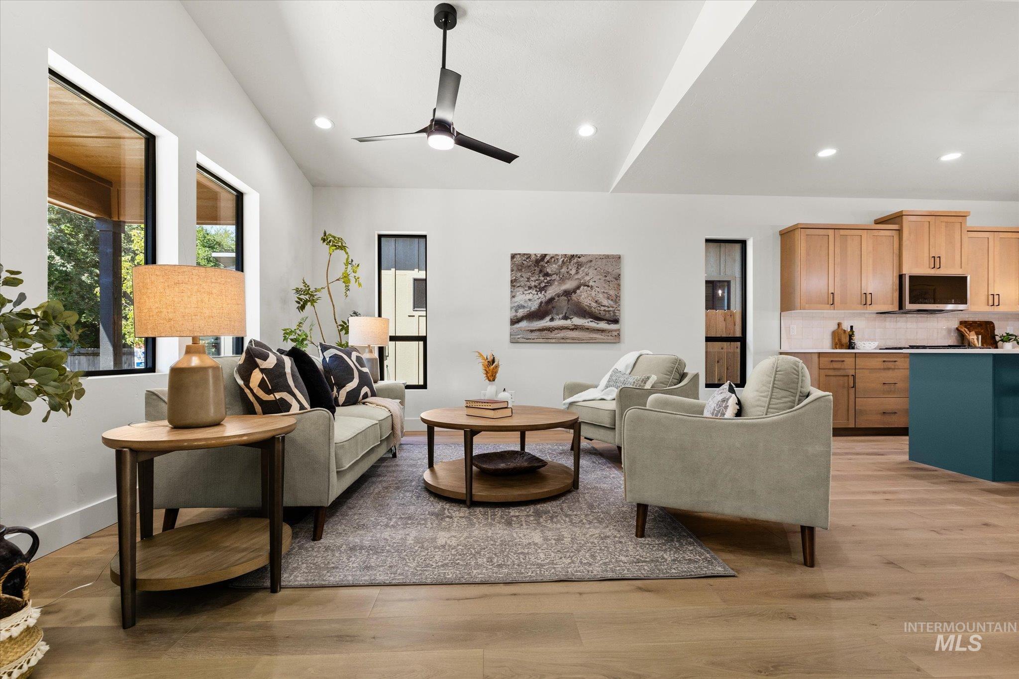 Living room with light wood-style floors, recessed lighting, and a ceiling fan