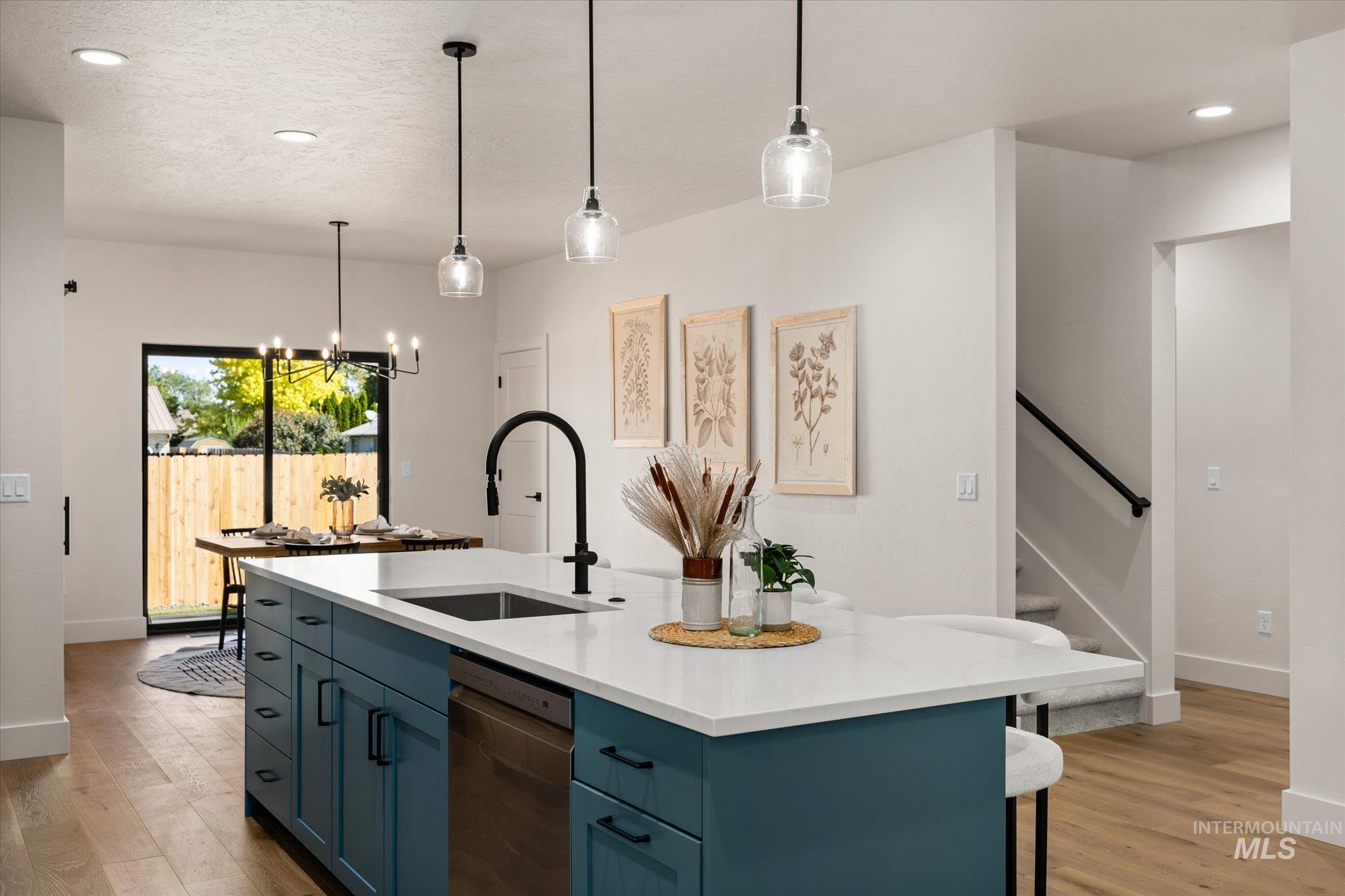 Kitchen featuring recessed lighting, blue cabinetry, light wood-style floors, a kitchen island with sink, and dishwasher
