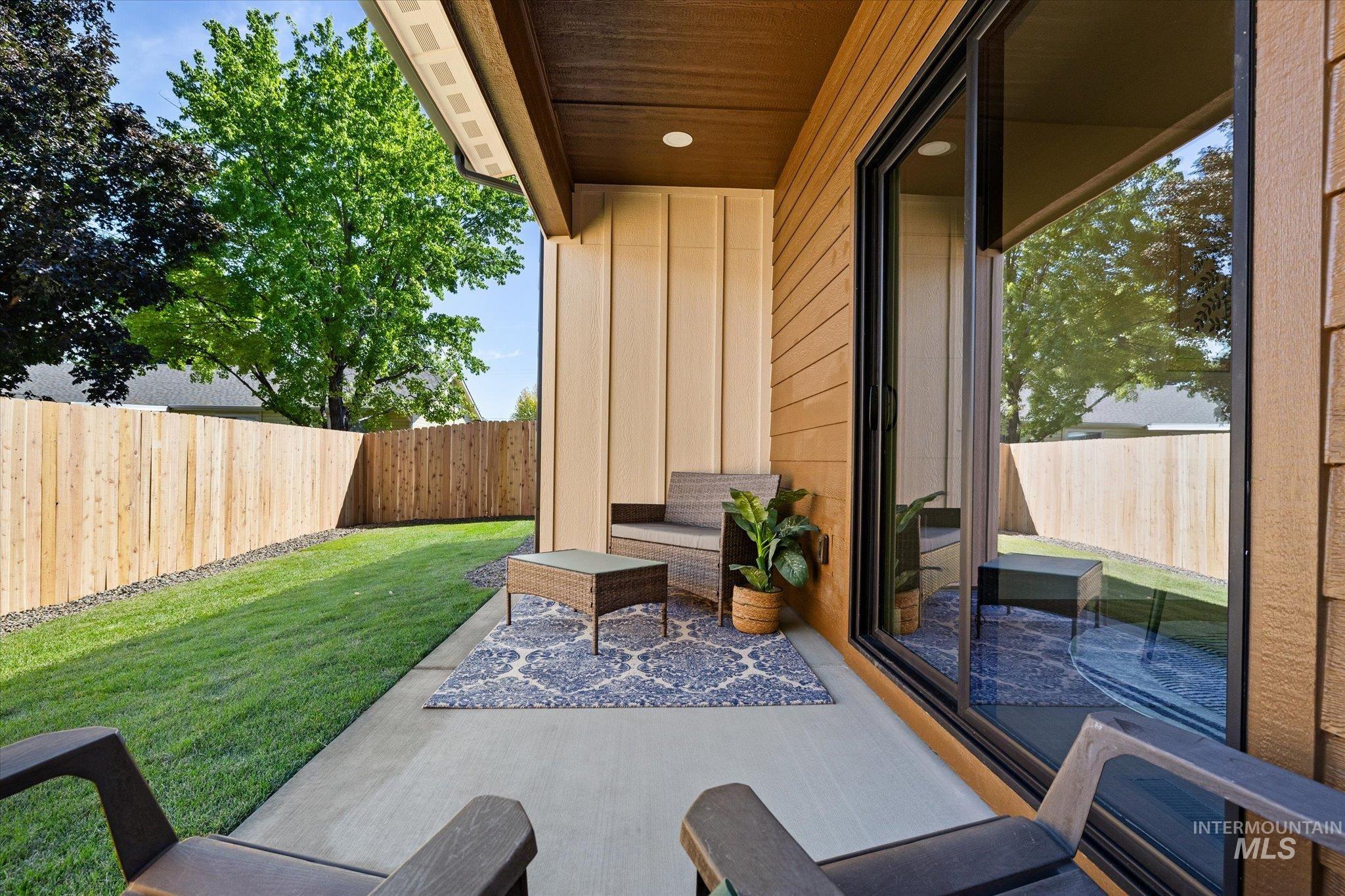Fenced backyard featuring a patio