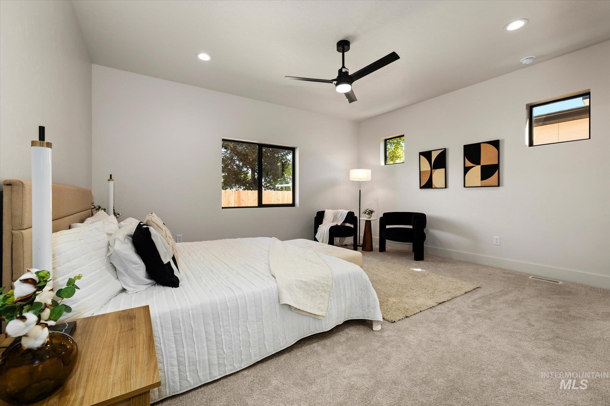 Carpeted bedroom with recessed lighting and a ceiling fan