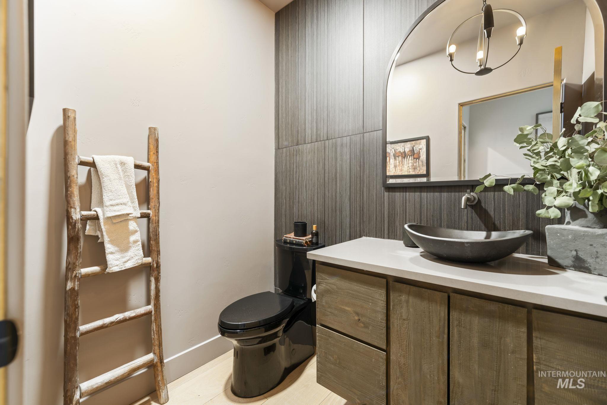 Powder Bathroom featuring vanity and toilet. Main Floor