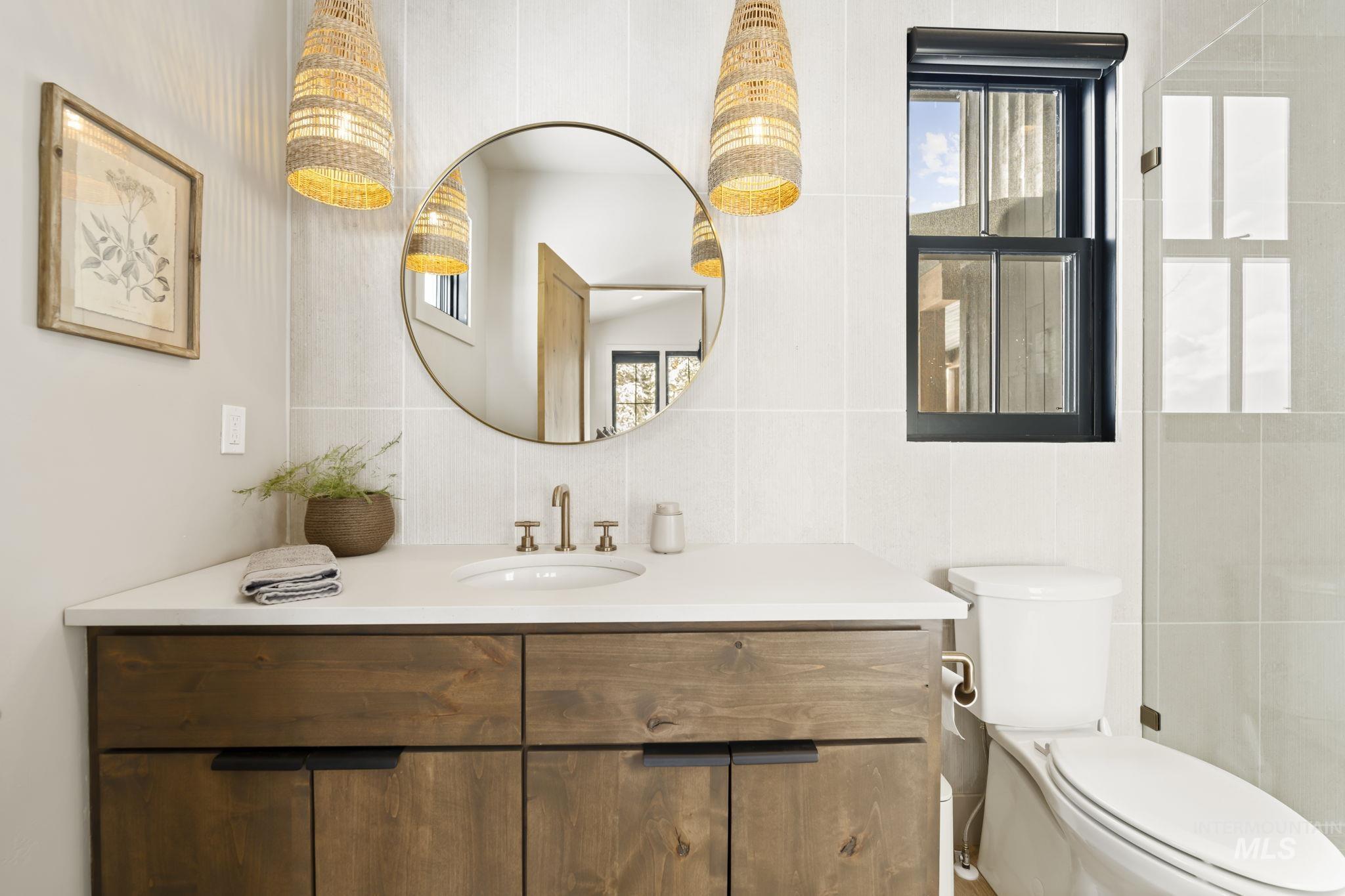 Jr Suite Bathroom with vanity and tile walls