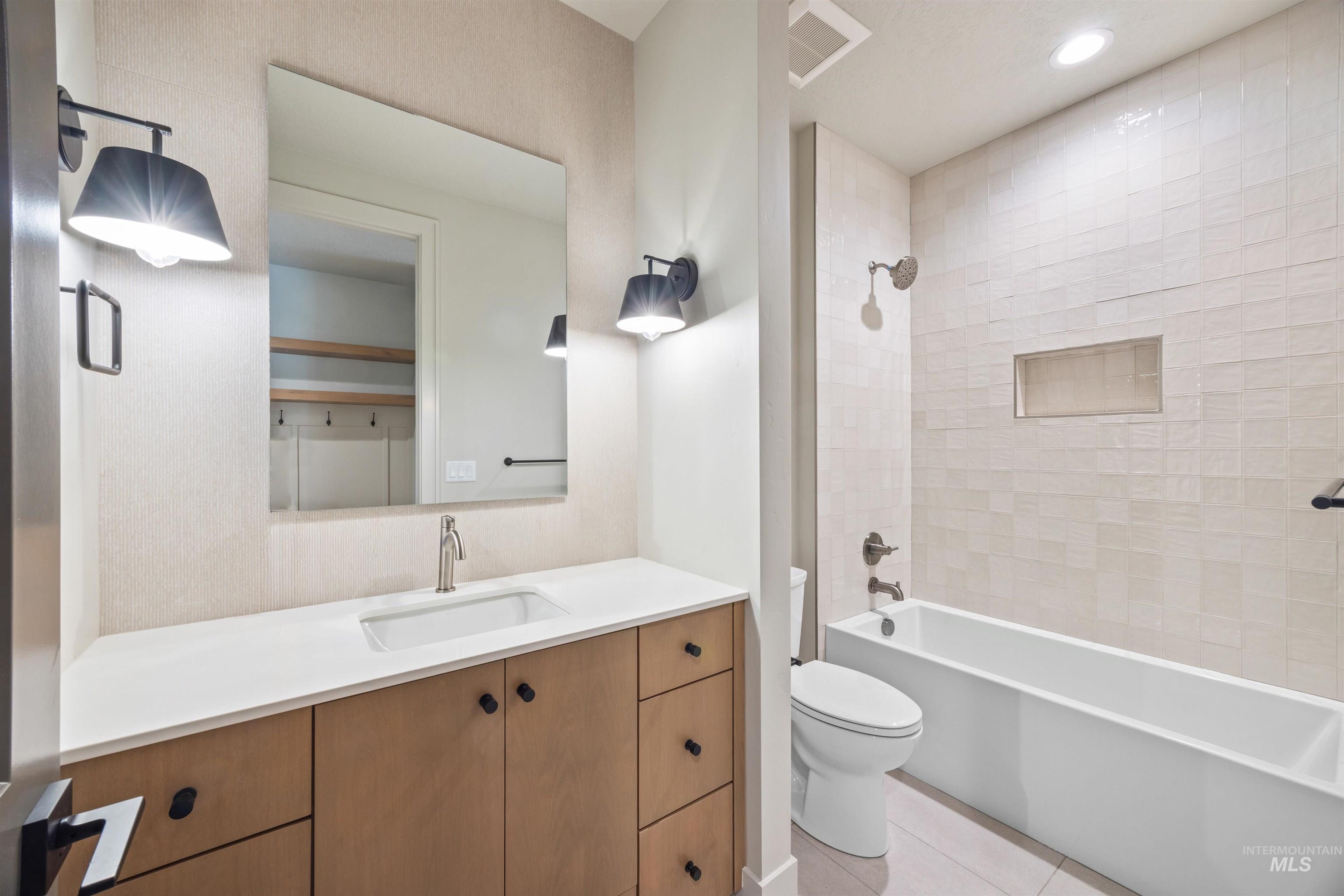 Full bath featuring vanity, tub / shower combination, recessed lighting, and light tile patterned floors
