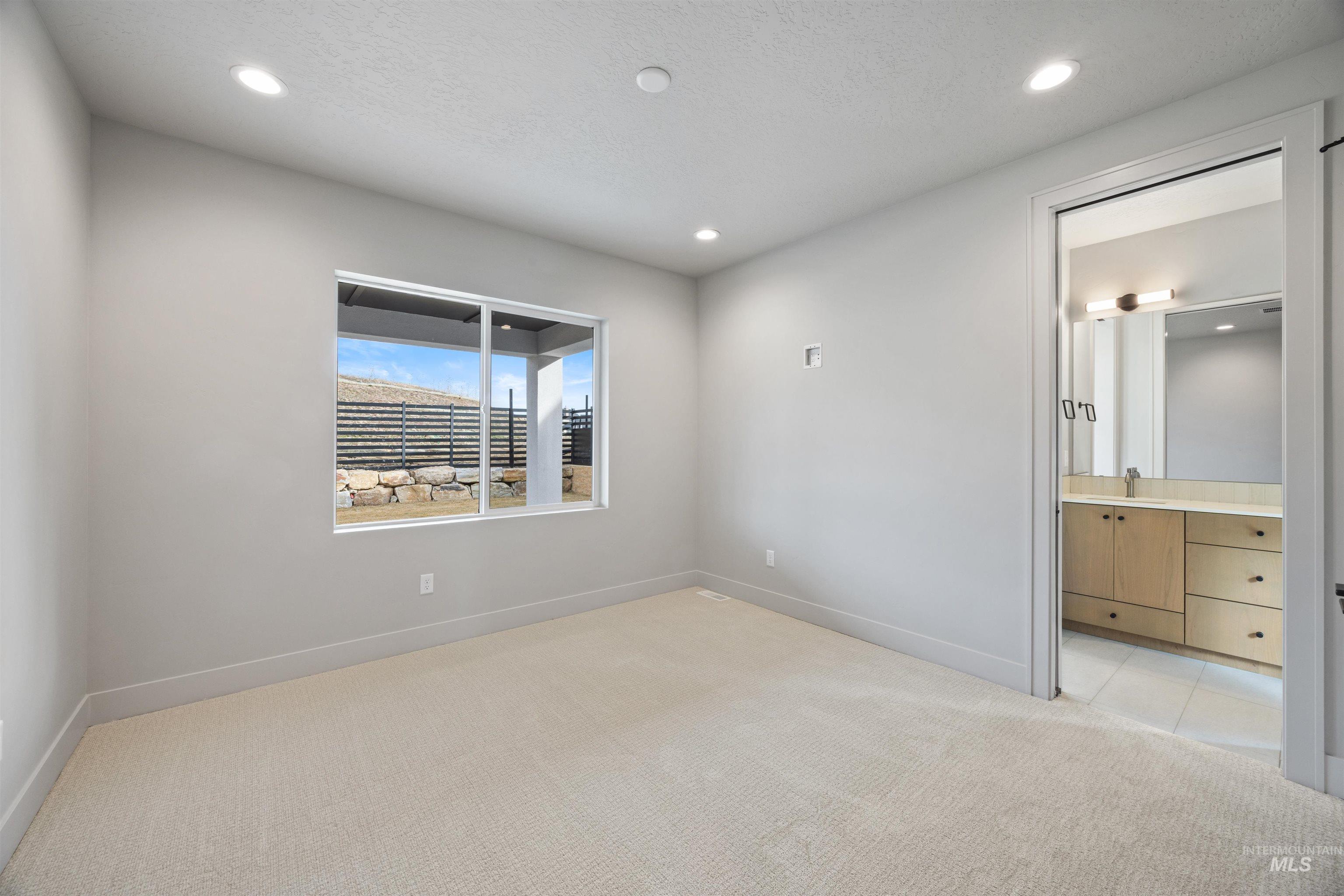 Unfurnished bedroom featuring light colored carpet and recessed lighting