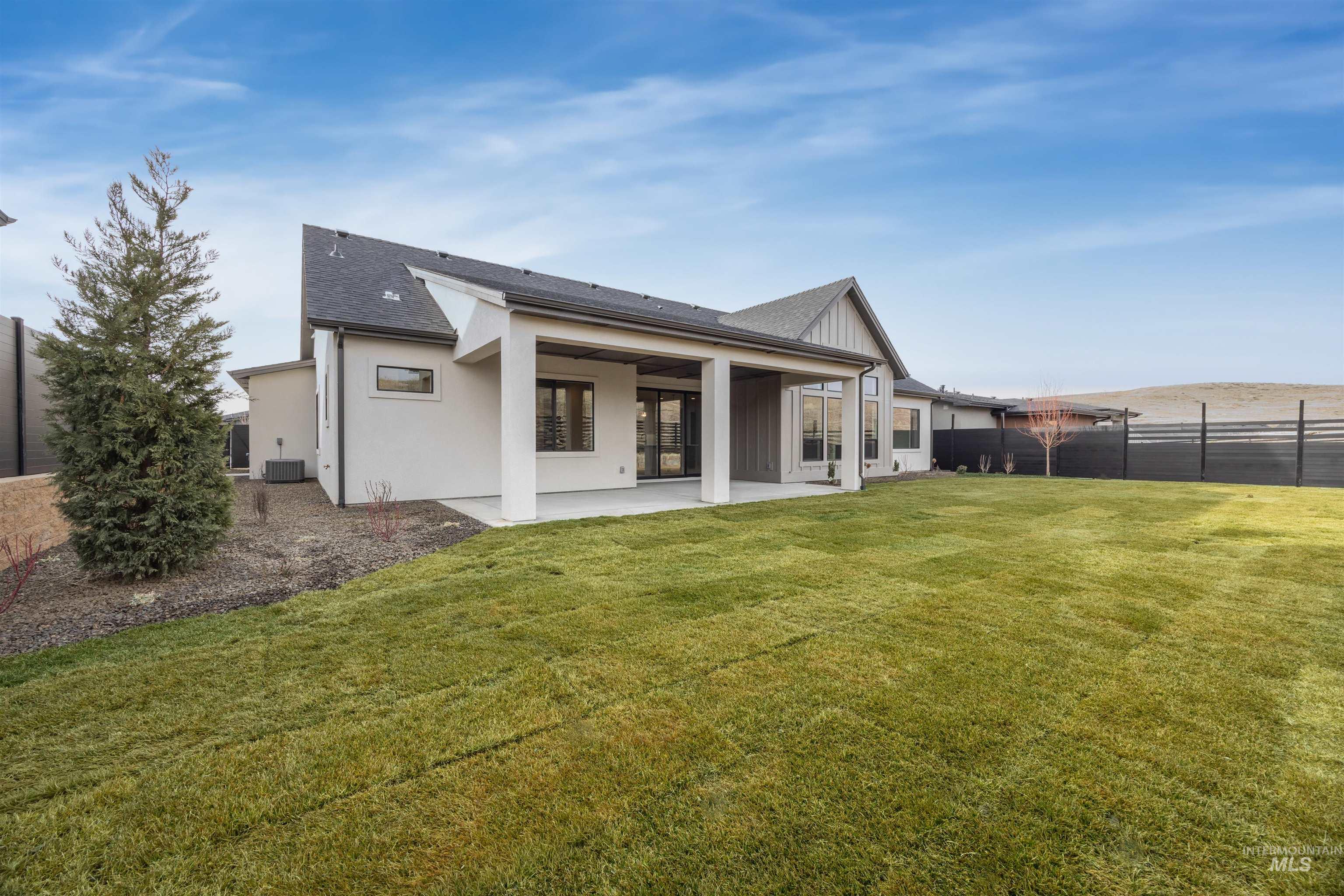 Back of property featuring a patio area, roof with shingles, and stucco siding