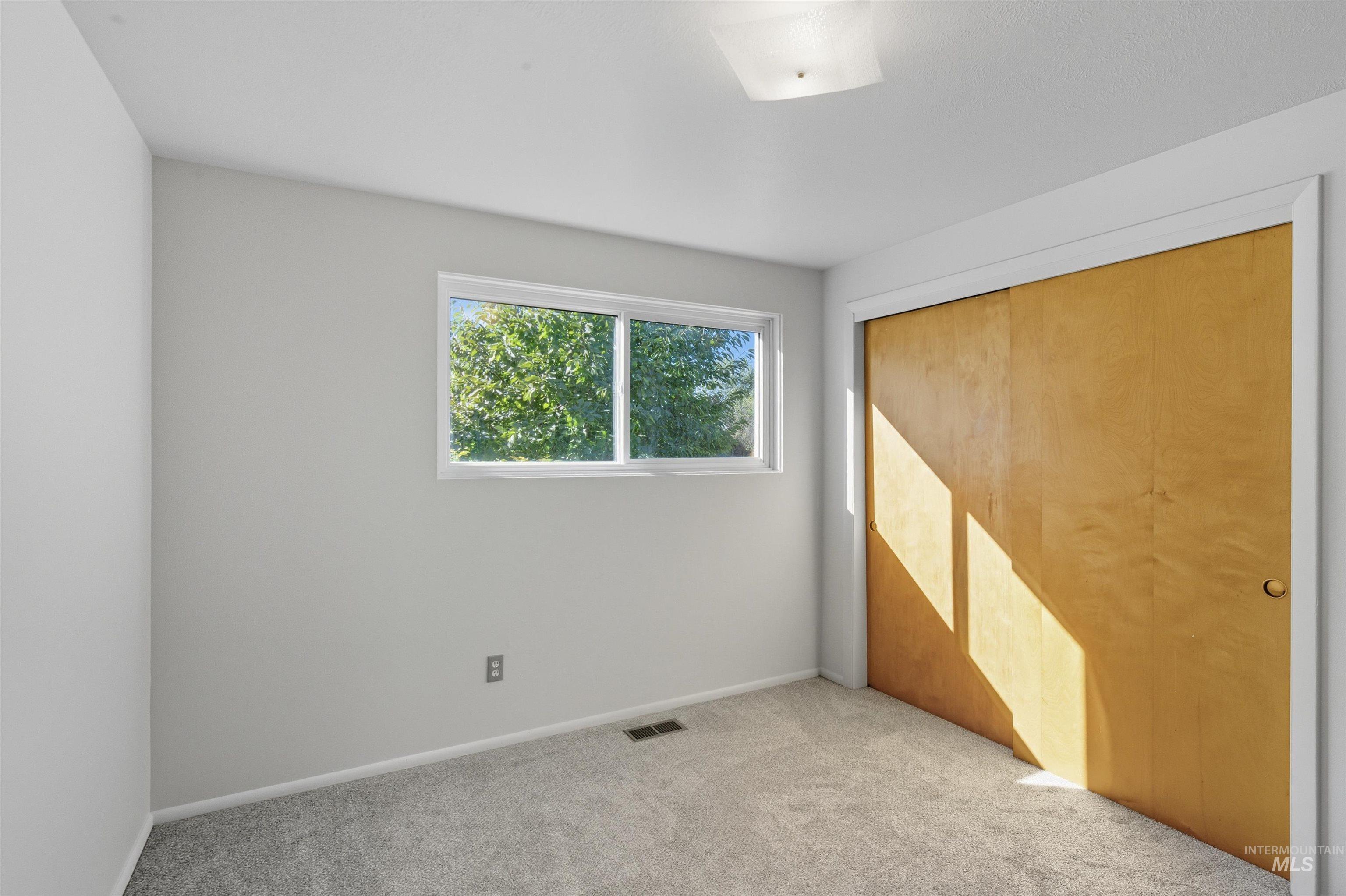 Unfurnished bedroom with carpet flooring and a closet