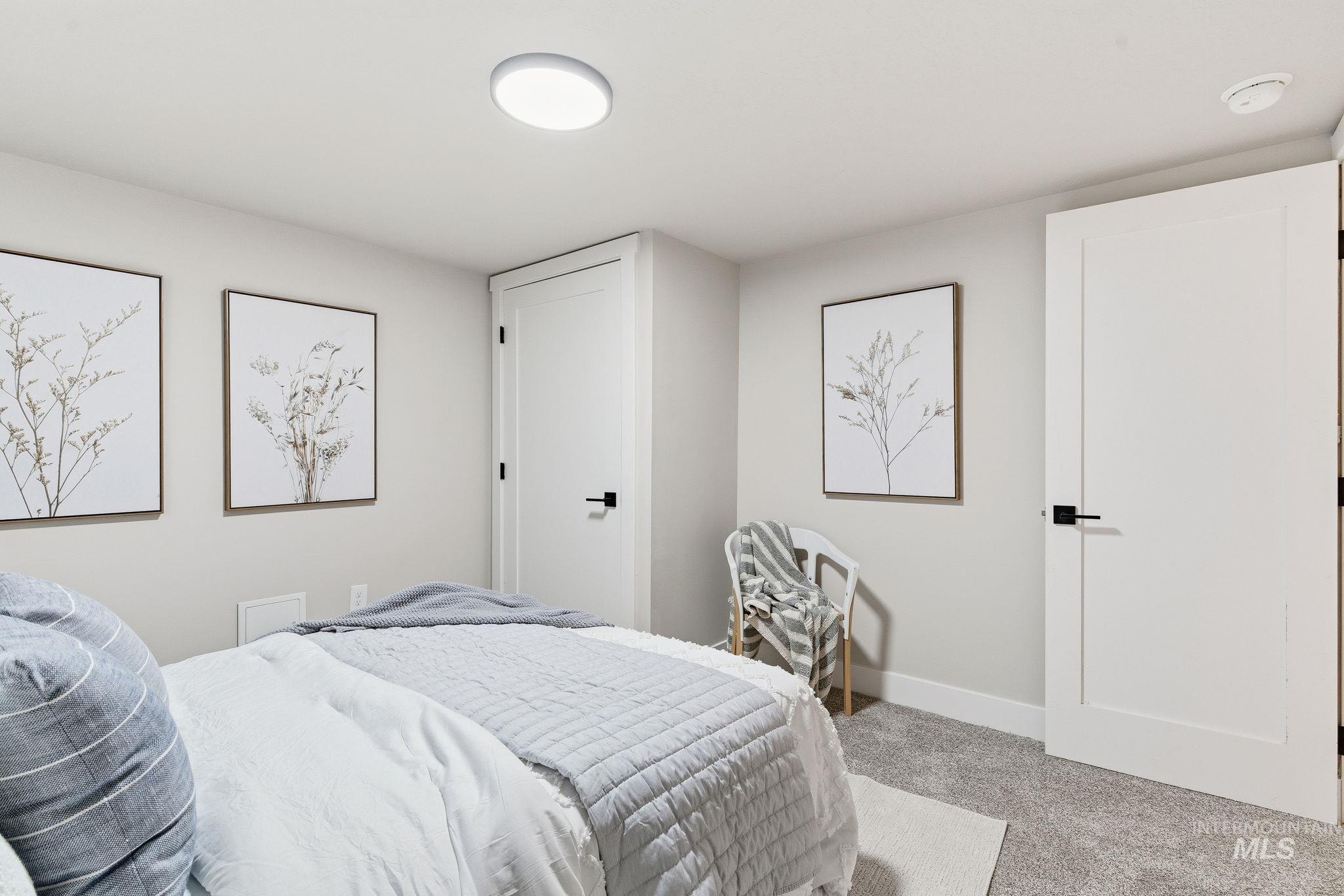 Bedroom featuring carpet floors and baseboards