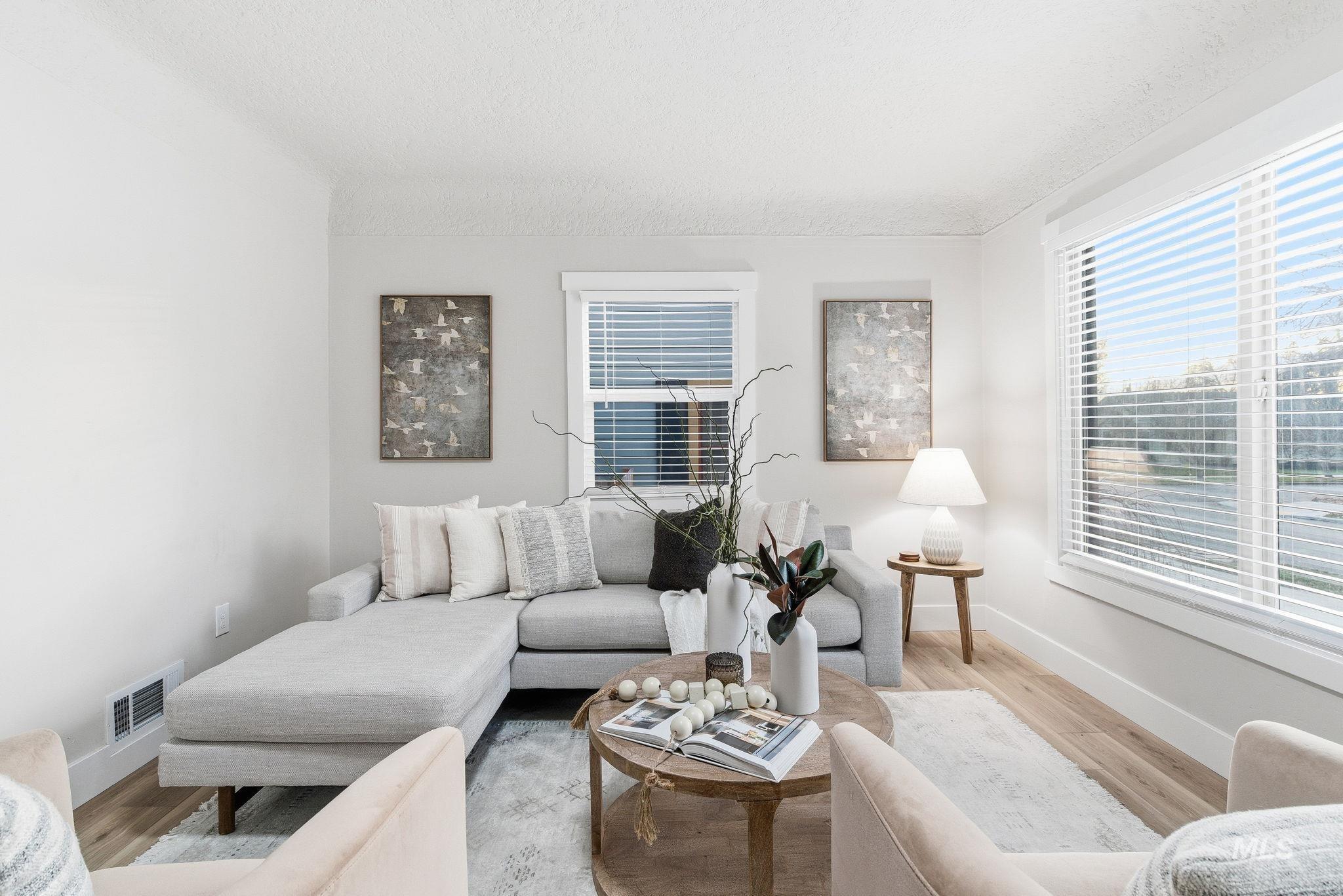 Living room with wood finished floors and a textured ceiling