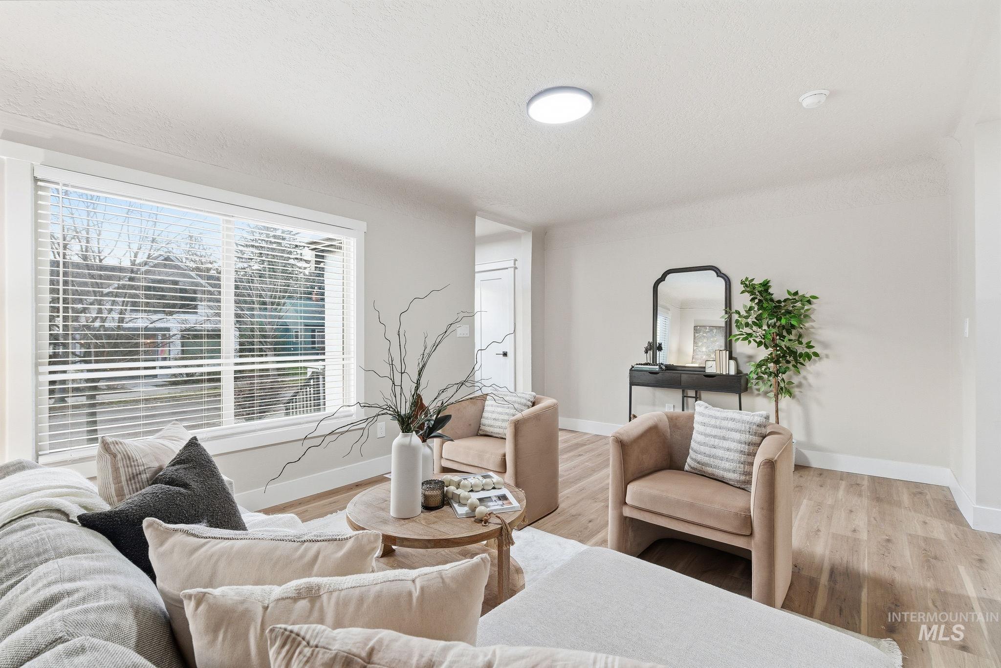 Living area featuring wood finished floors and a textured ceiling