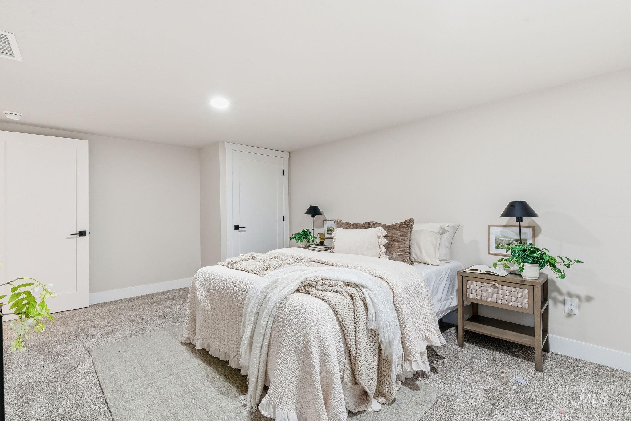 Bedroom featuring light colored carpet and recessed lighting