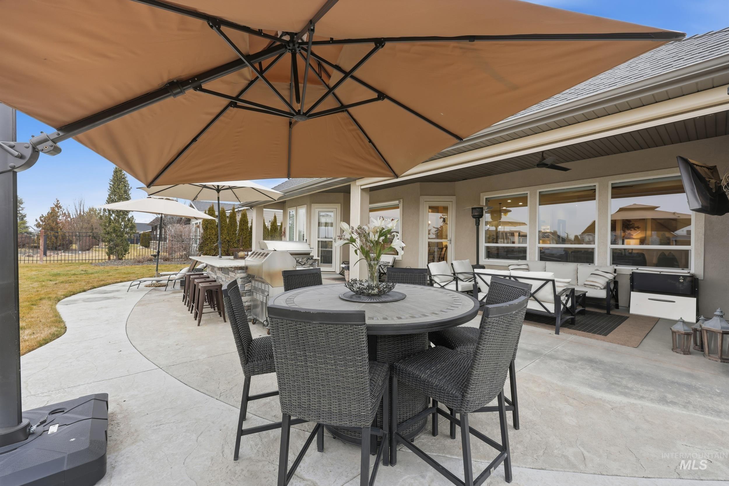 View of patio / terrace with outdoor dining area, an outdoor bar, and an outdoor kitchen