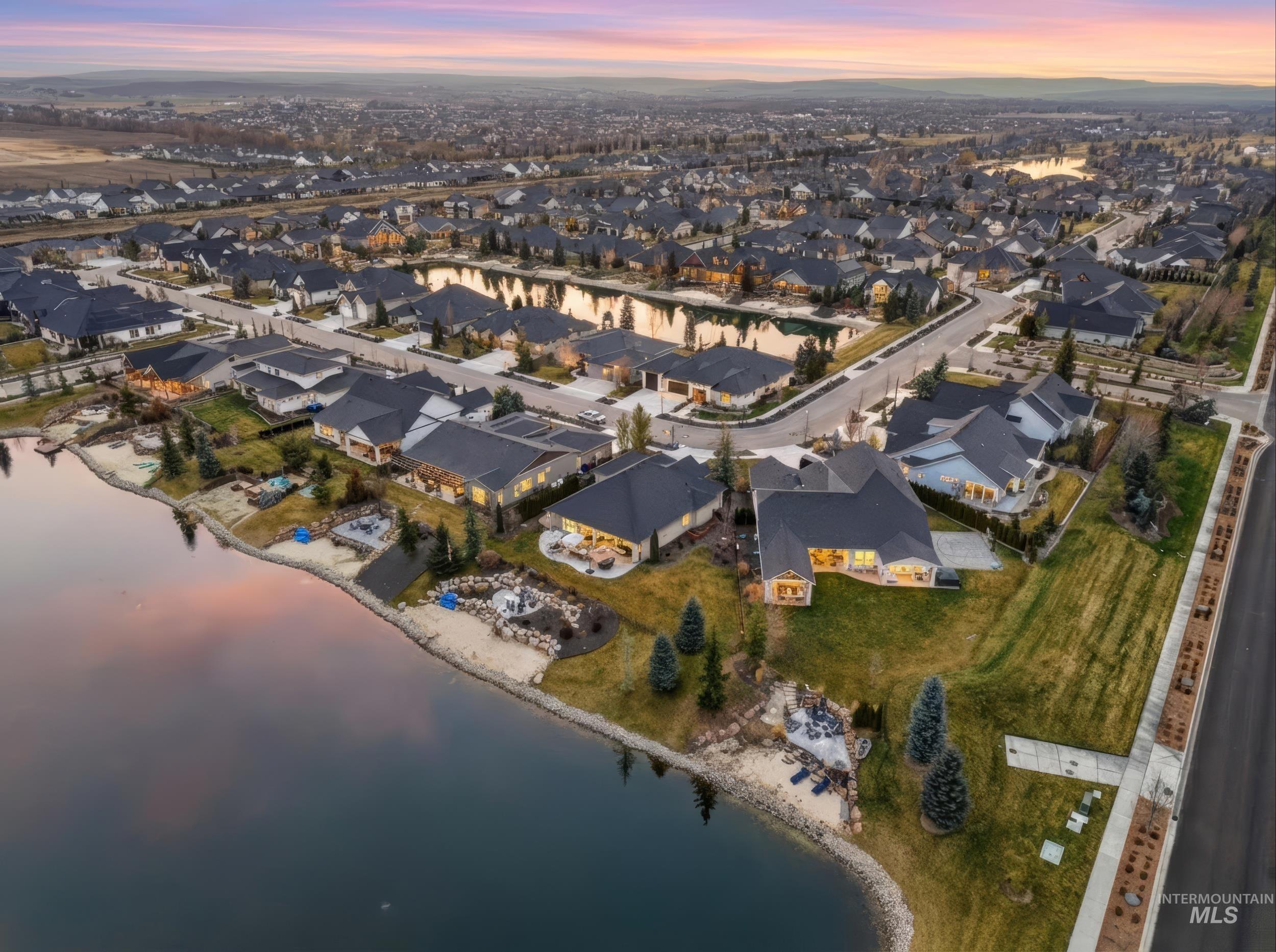 View of property location featuring a nearby body of water and nearby suburban area