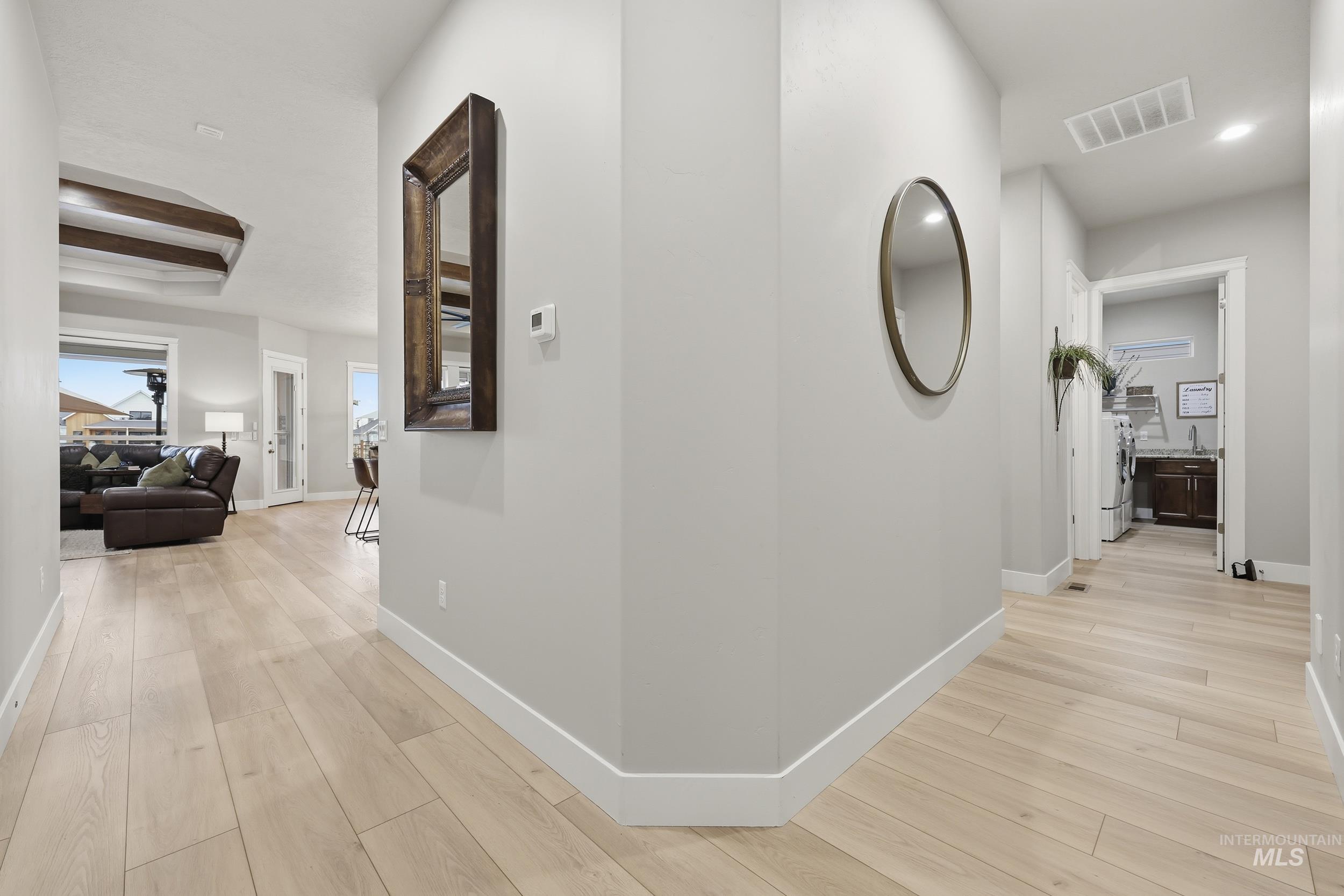 Hallway featuring light wood-type flooring and recessed lighting