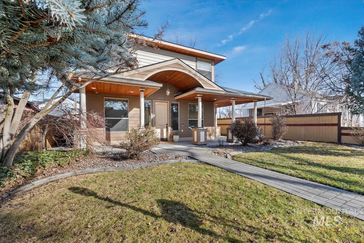 View of front of house featuring a porch and a front lawn