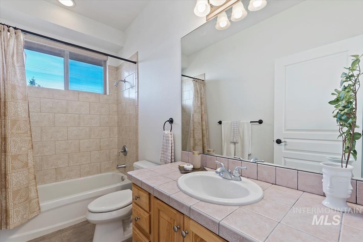 Bathroom with vanity and shower / bath combination with curtain