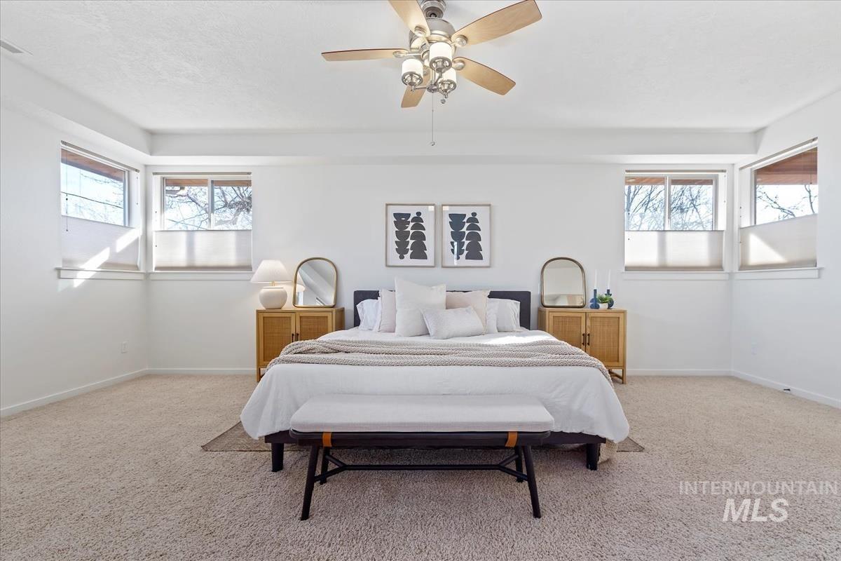Bedroom featuring light carpet and a ceiling fan