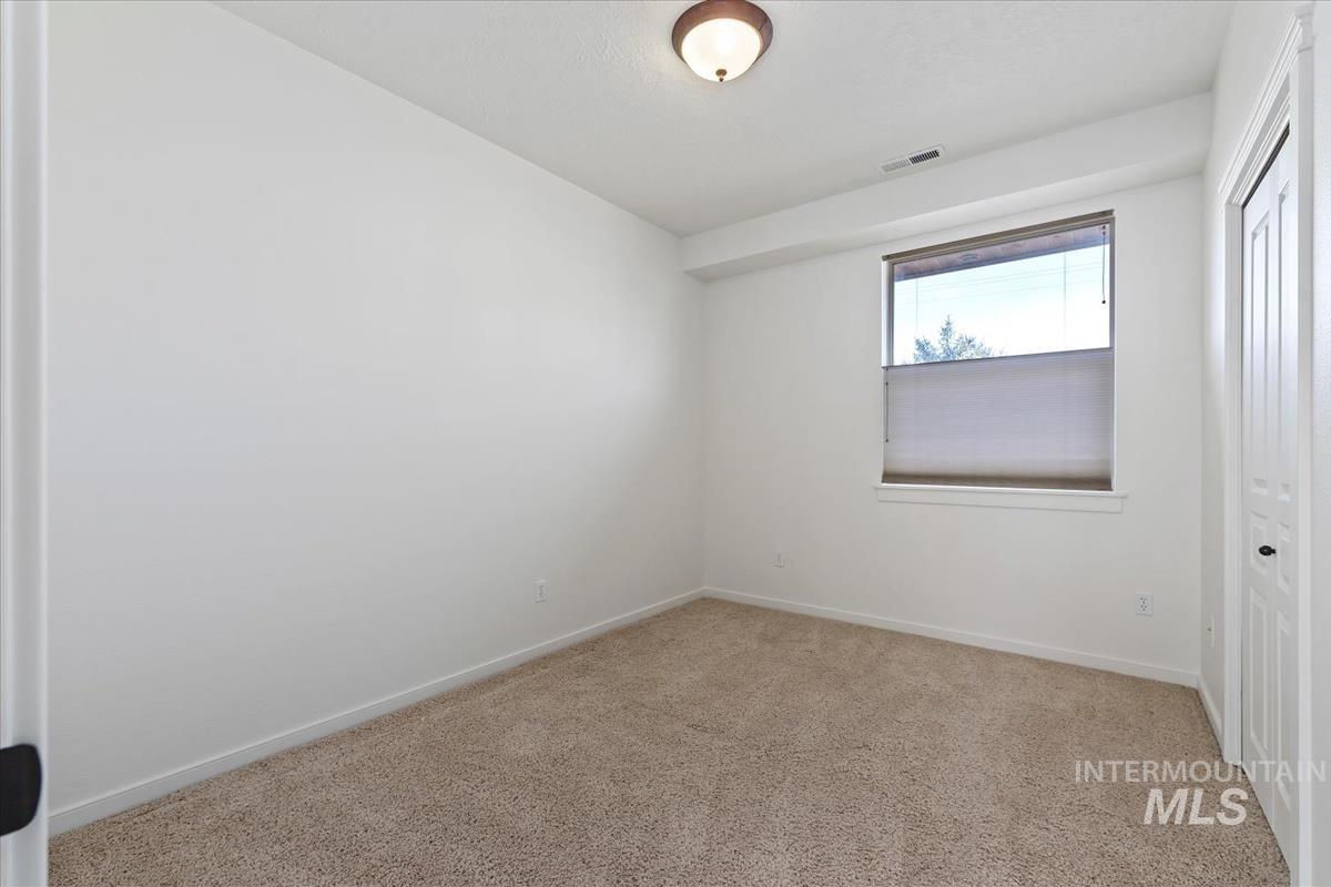 Unfurnished bedroom featuring carpet floors and a closet