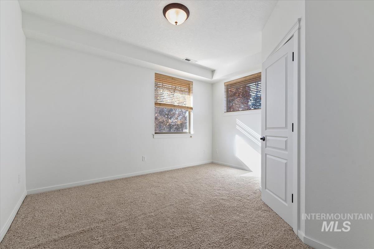 Unfurnished bedroom with baseboards and carpet