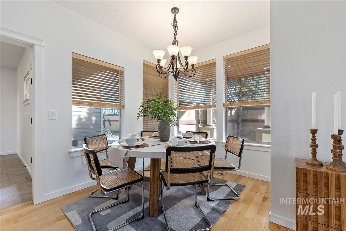 Dining room featuring light wood-style flooring and a chandelier