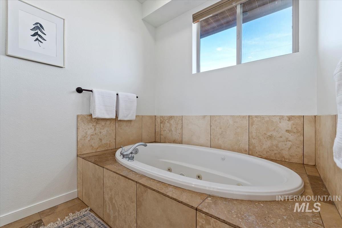 Bathroom with a tub with jets