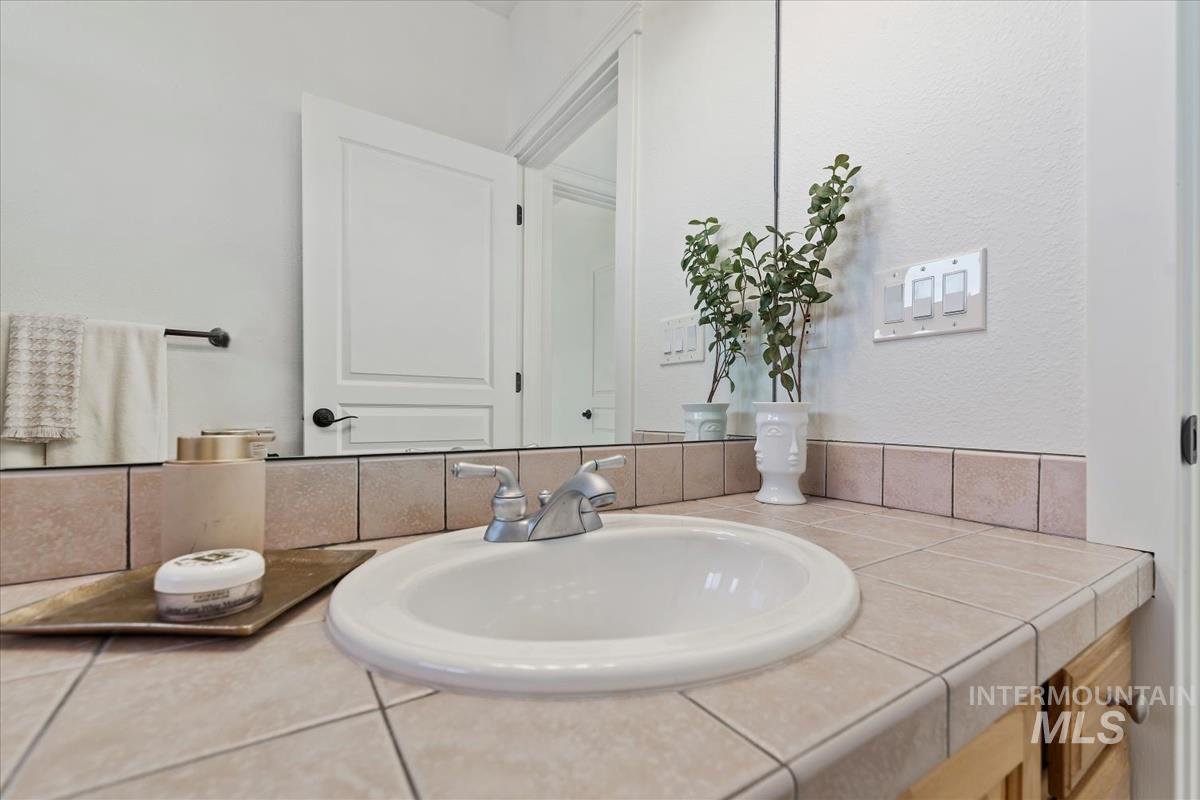 Bathroom with vanity and a textured wall
