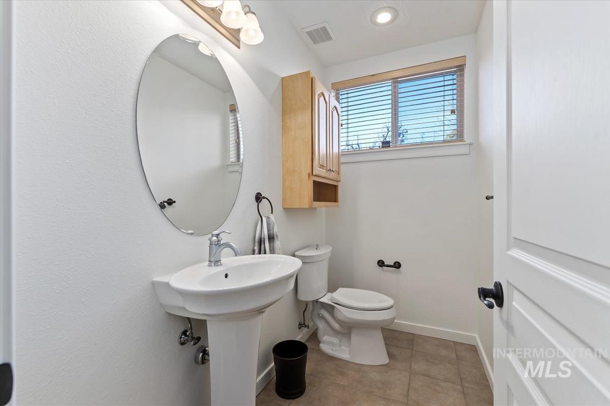 Half bathroom with tile patterned floors and recessed lighting