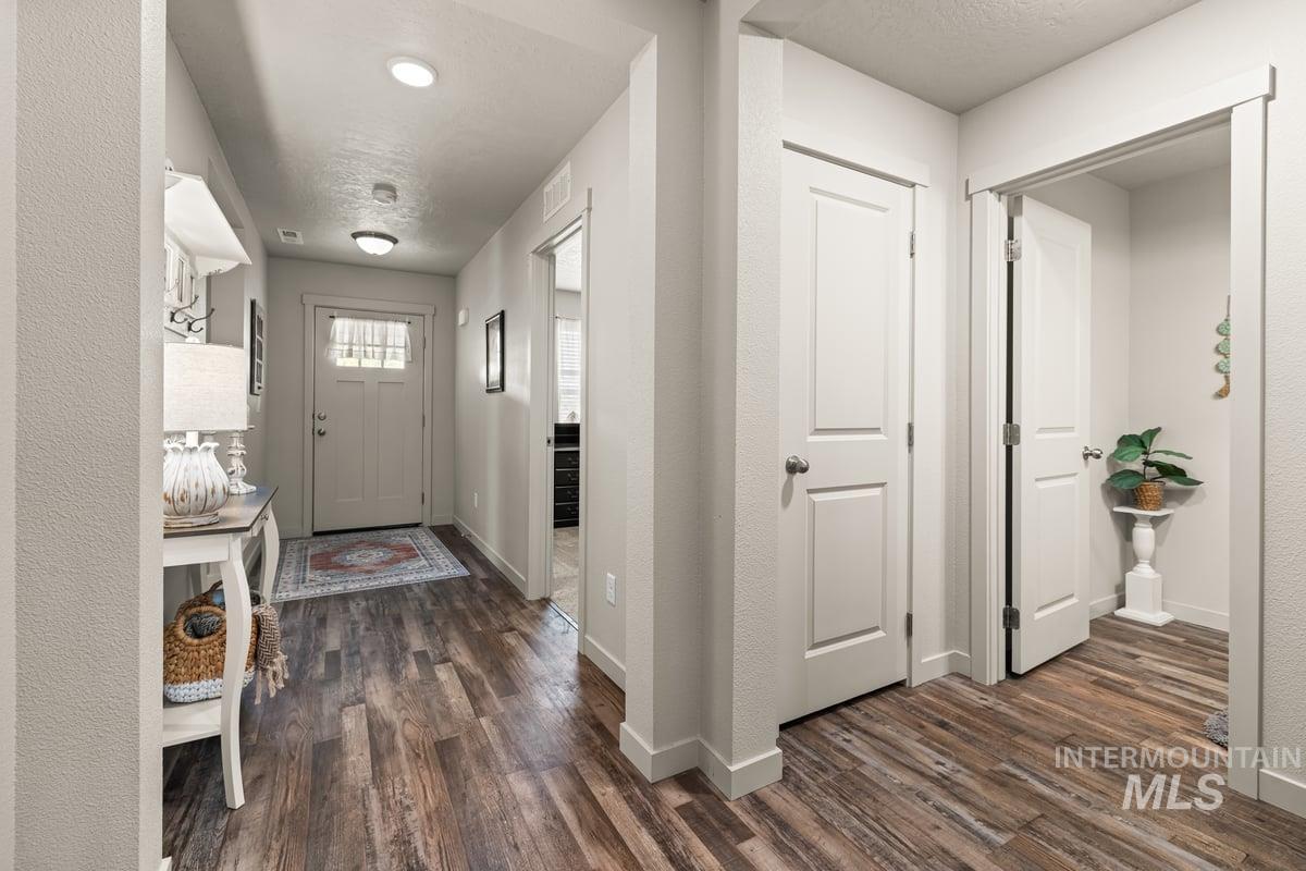 Entryway featuring dark wood-style floors and a textured ceiling