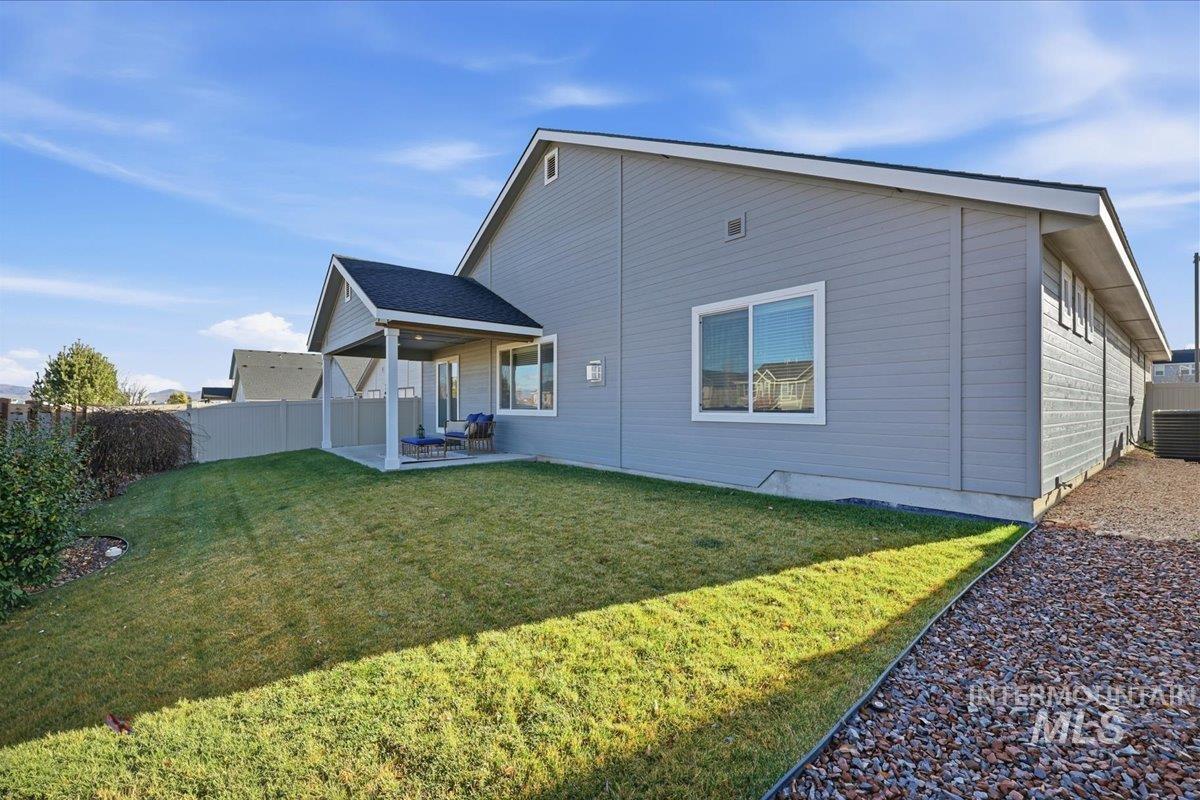 Rear view of property featuring a patio area and a fenced backyard