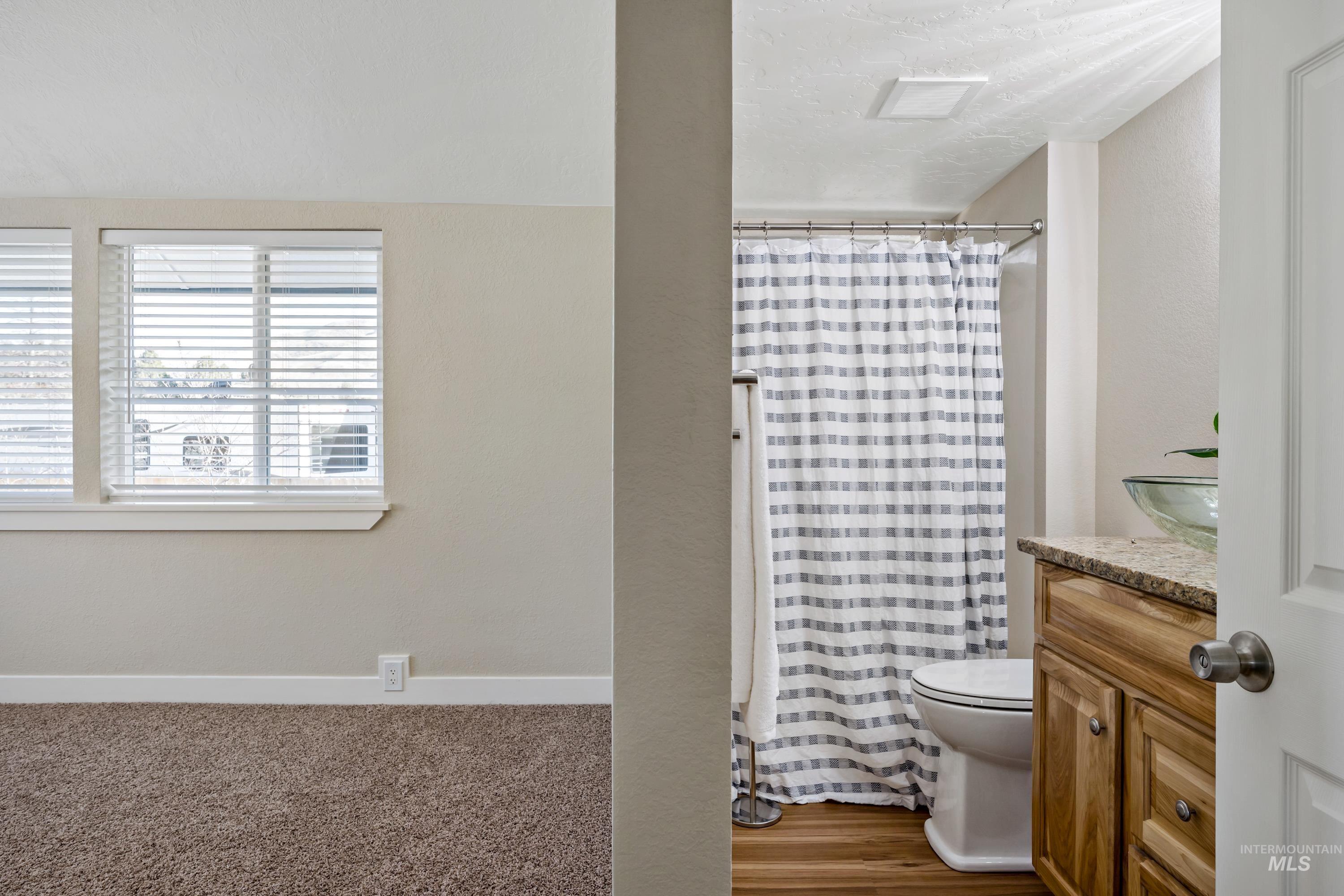 Full bath with vanity and a shower with curtain