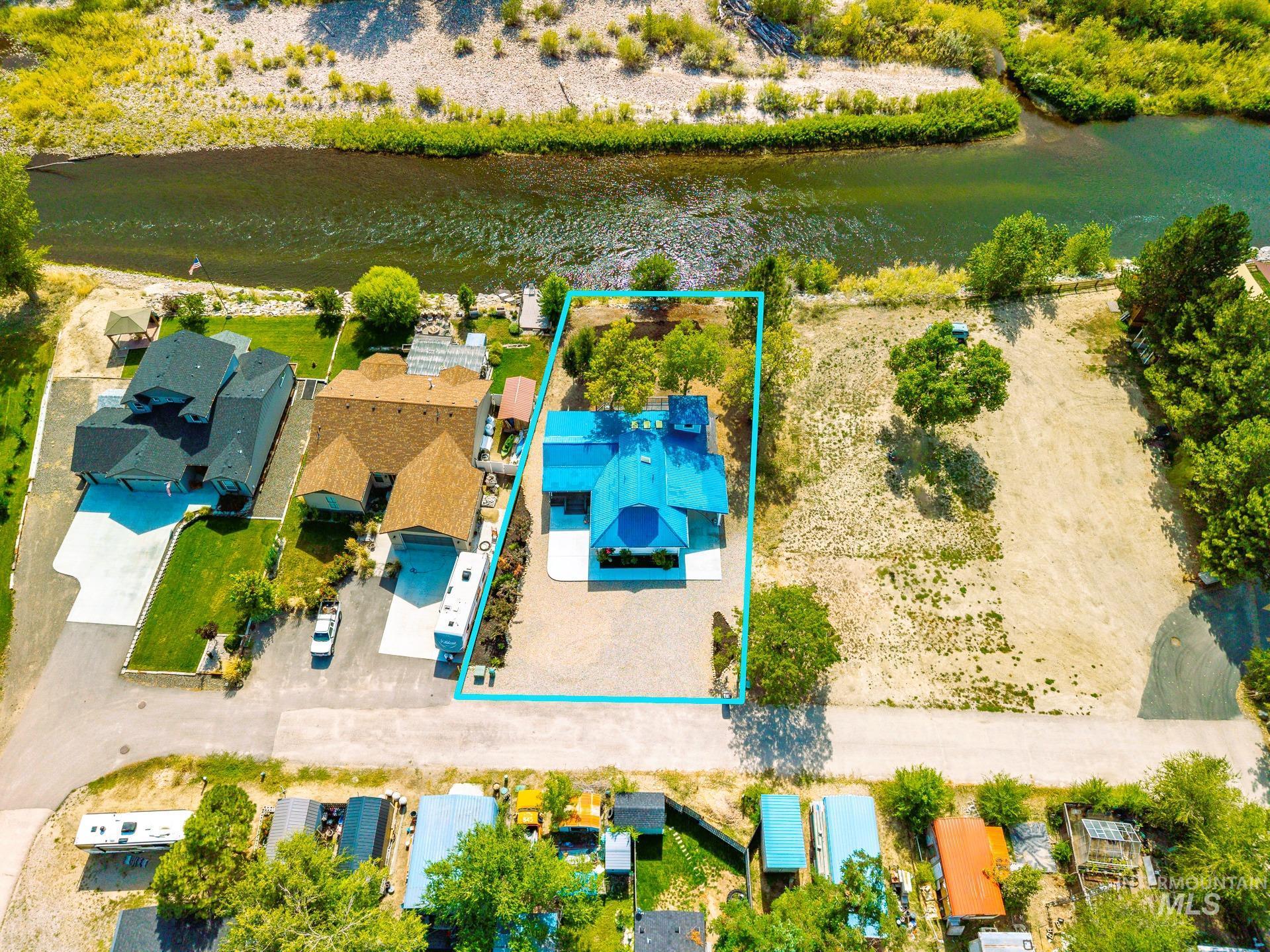 View of property location with a nearby body of water and property parcel outlined