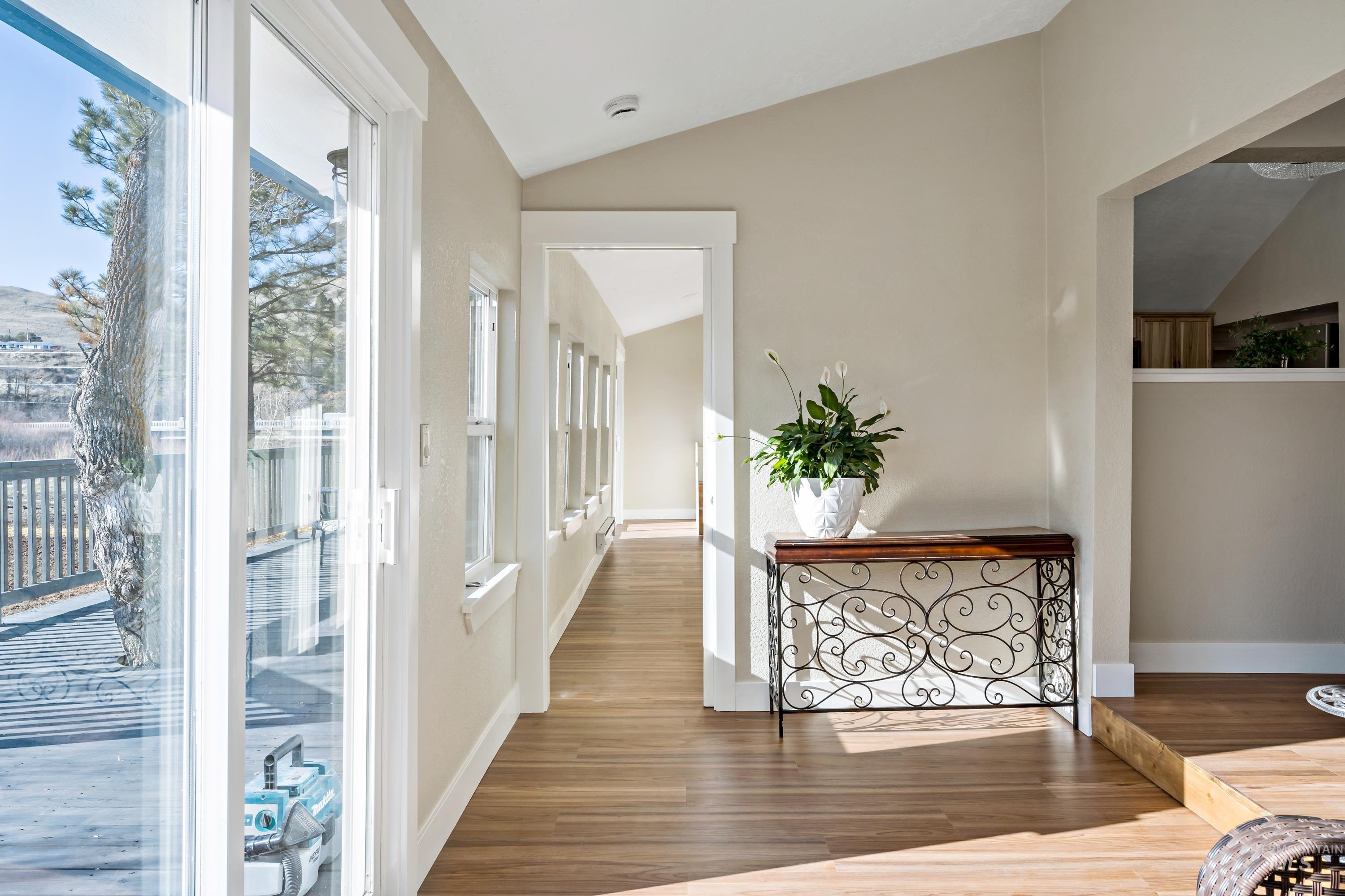 Entryway featuring lofted ceiling and wood finished floors