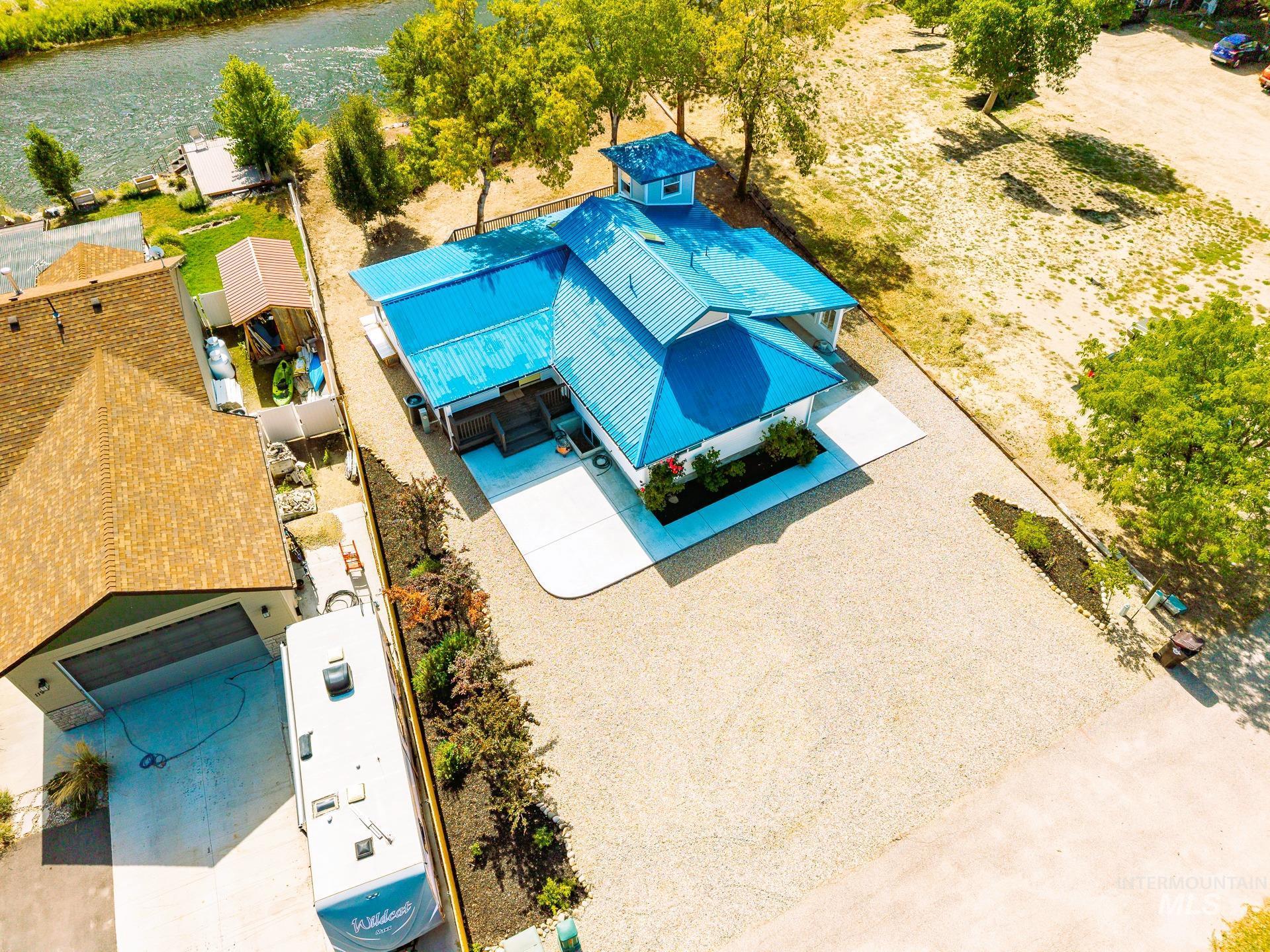 Aerial view of property and surrounding area featuring a nearby body of water