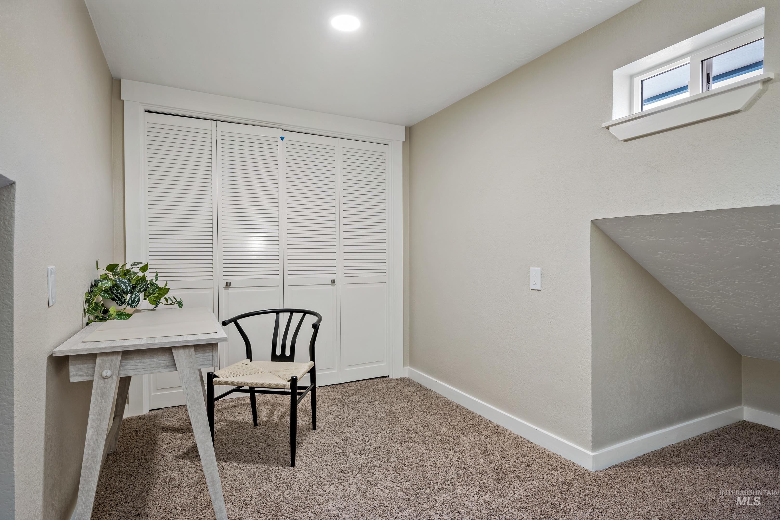Home office featuring carpet and baseboards