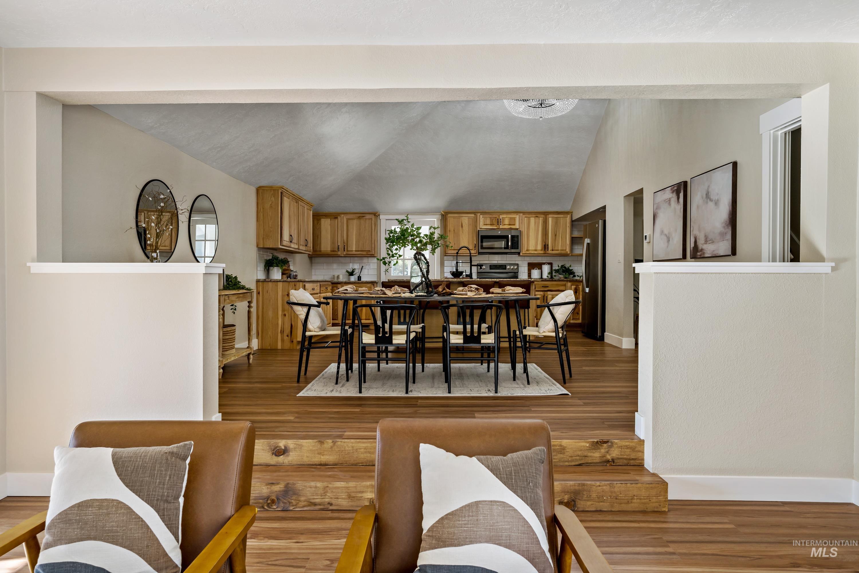Dining space featuring lofted ceiling and light wood finished floors