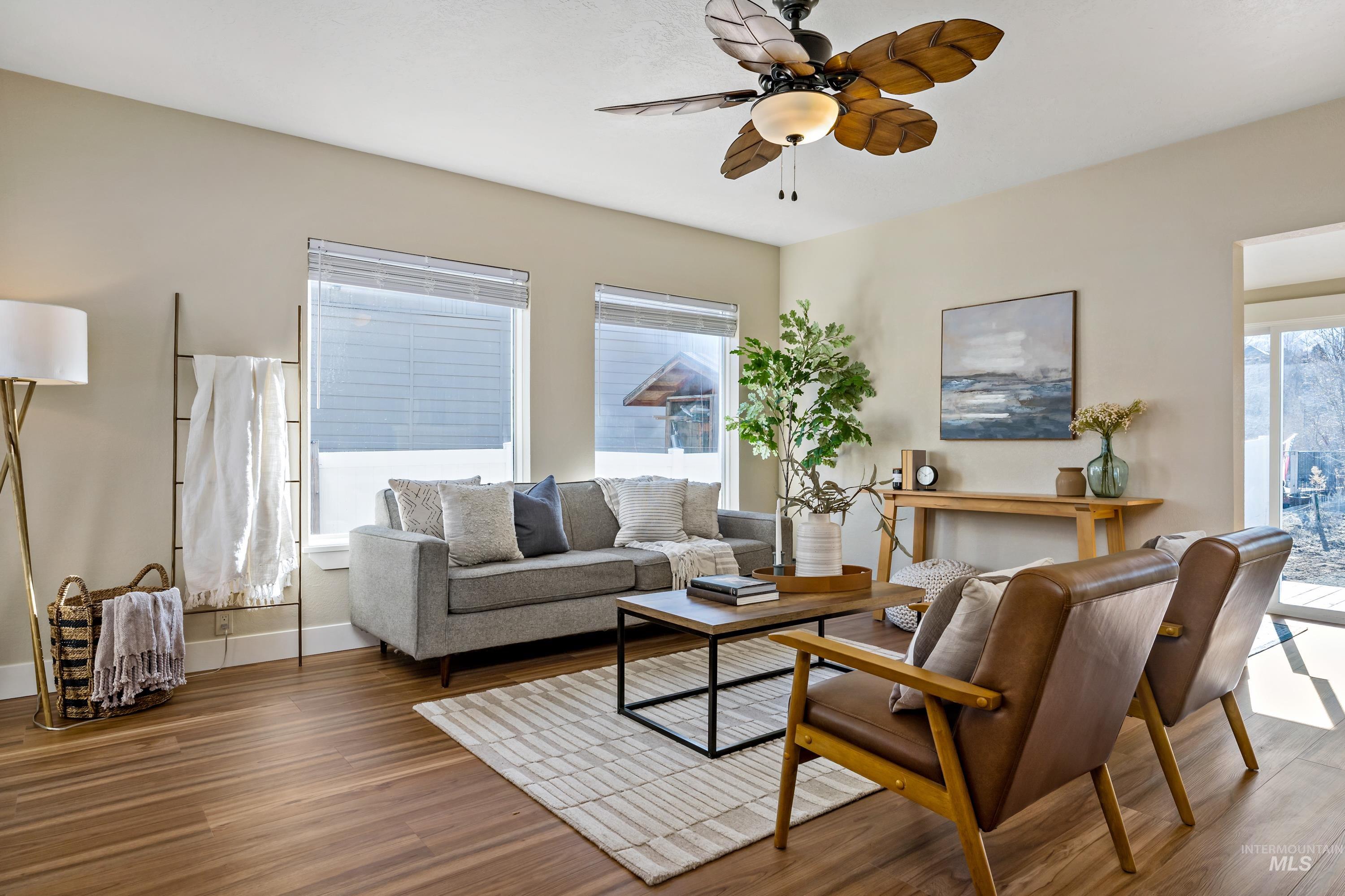 Living room featuring wood finished floors and ceiling fan