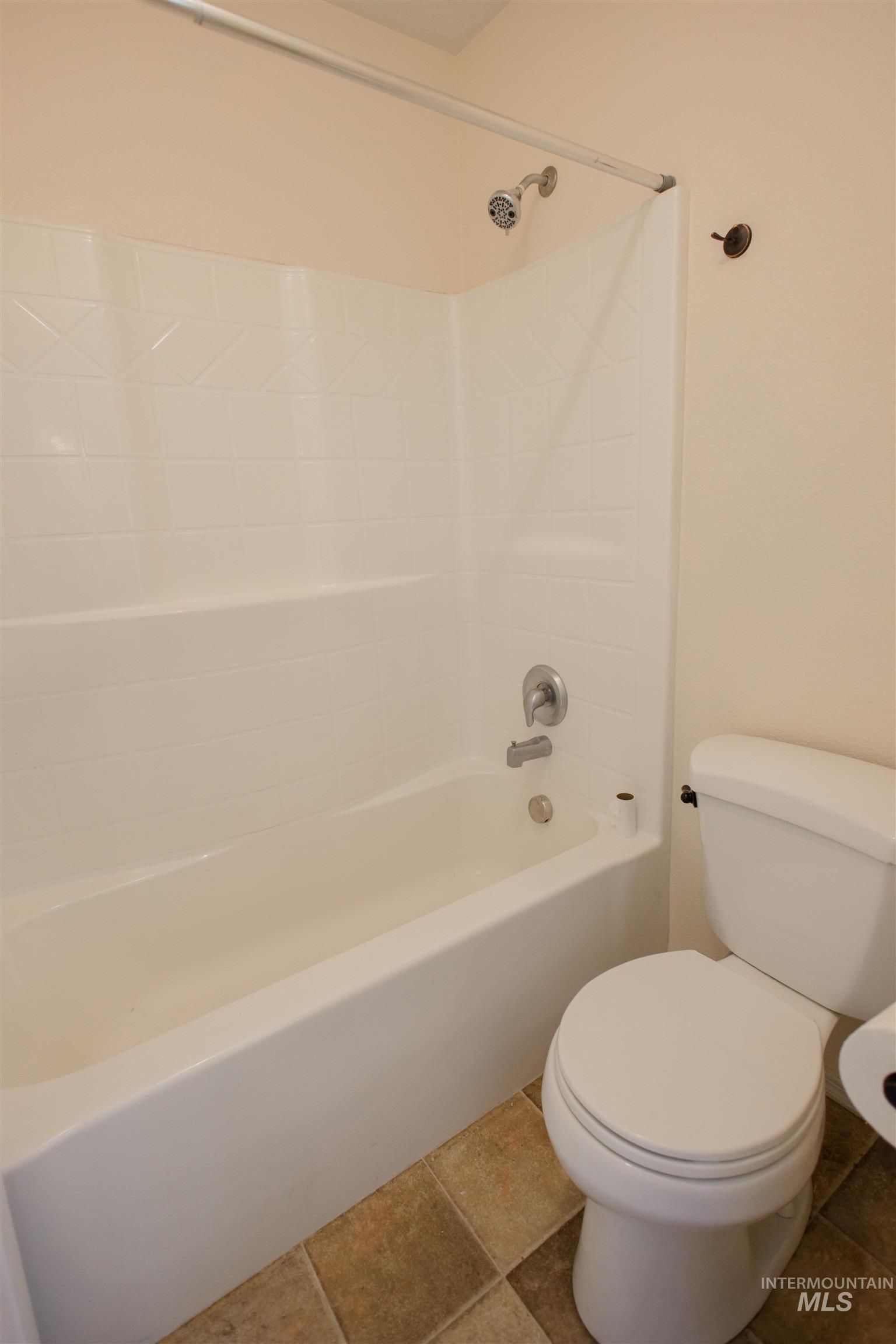 Full bathroom with tile patterned flooring and tub / shower combination
