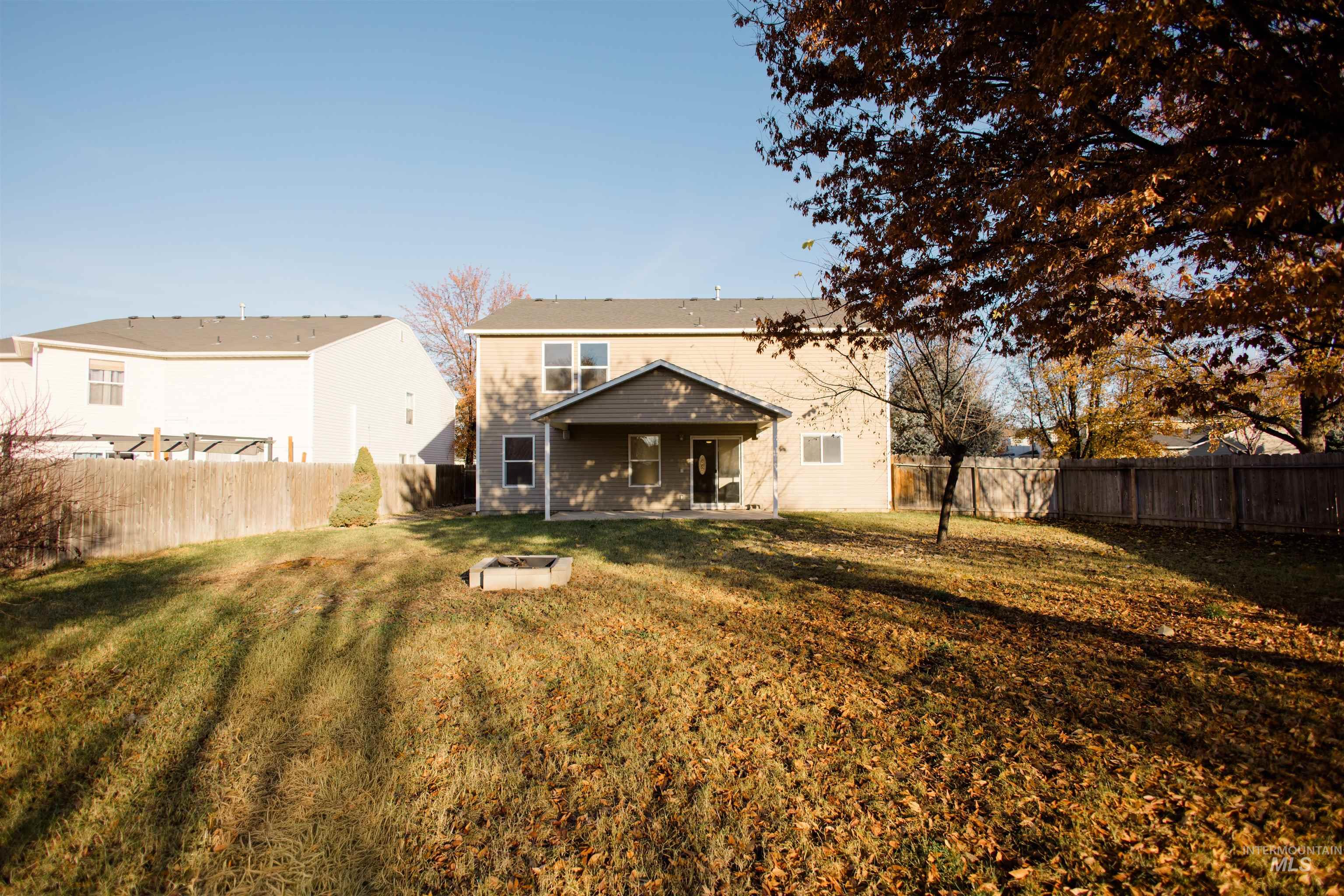 Back of property with a fenced backyard and a patio area