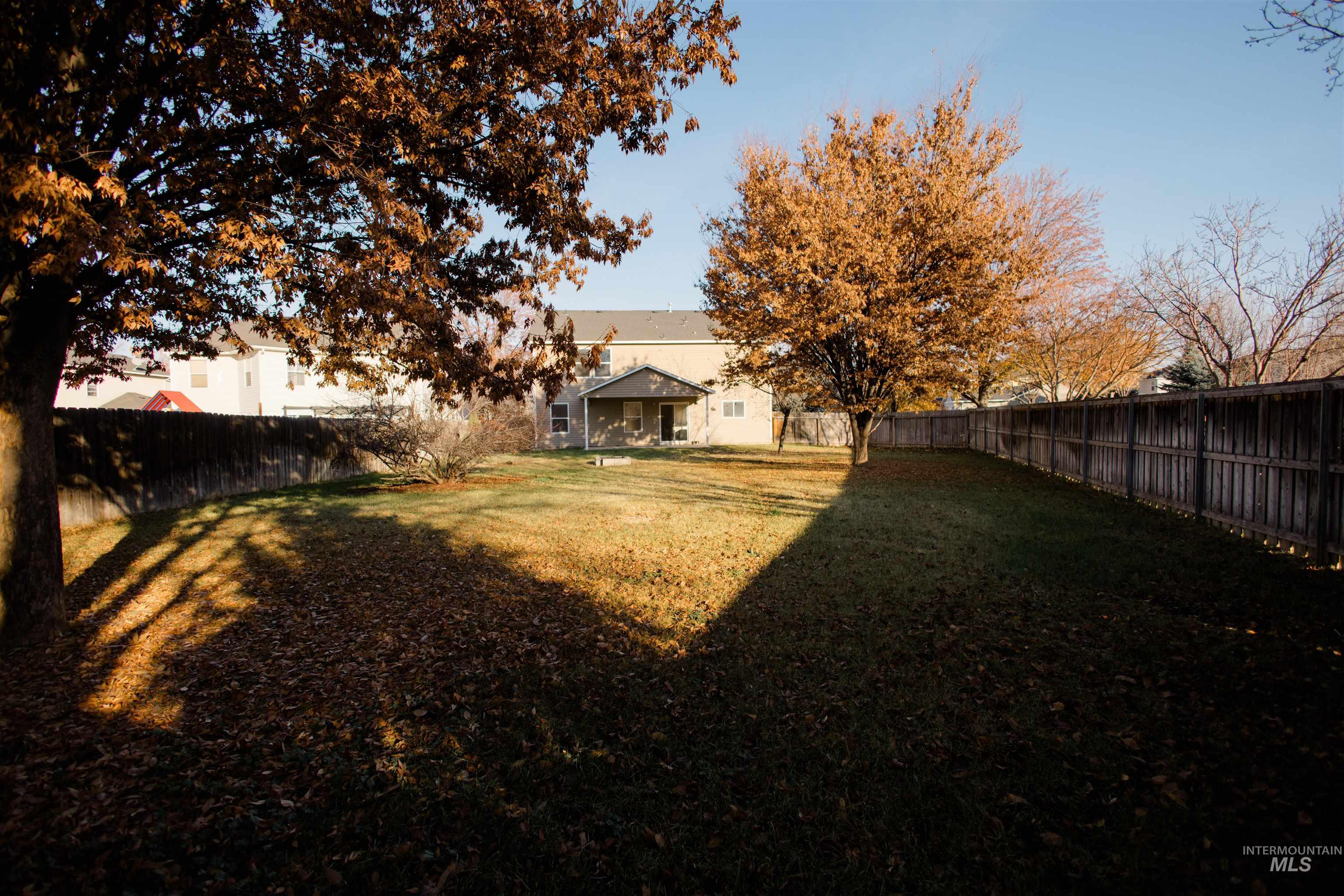 Rear view of house with a fenced backyard
