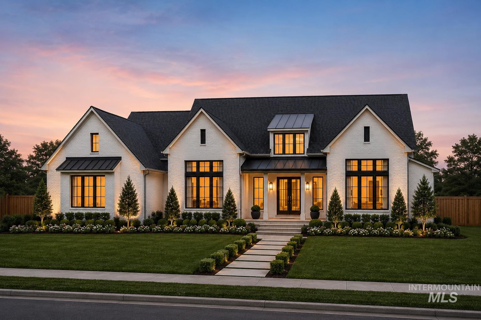 White brick exterior with dark shingle roofing, featuring a prominent front entrance with double glass-panel doors