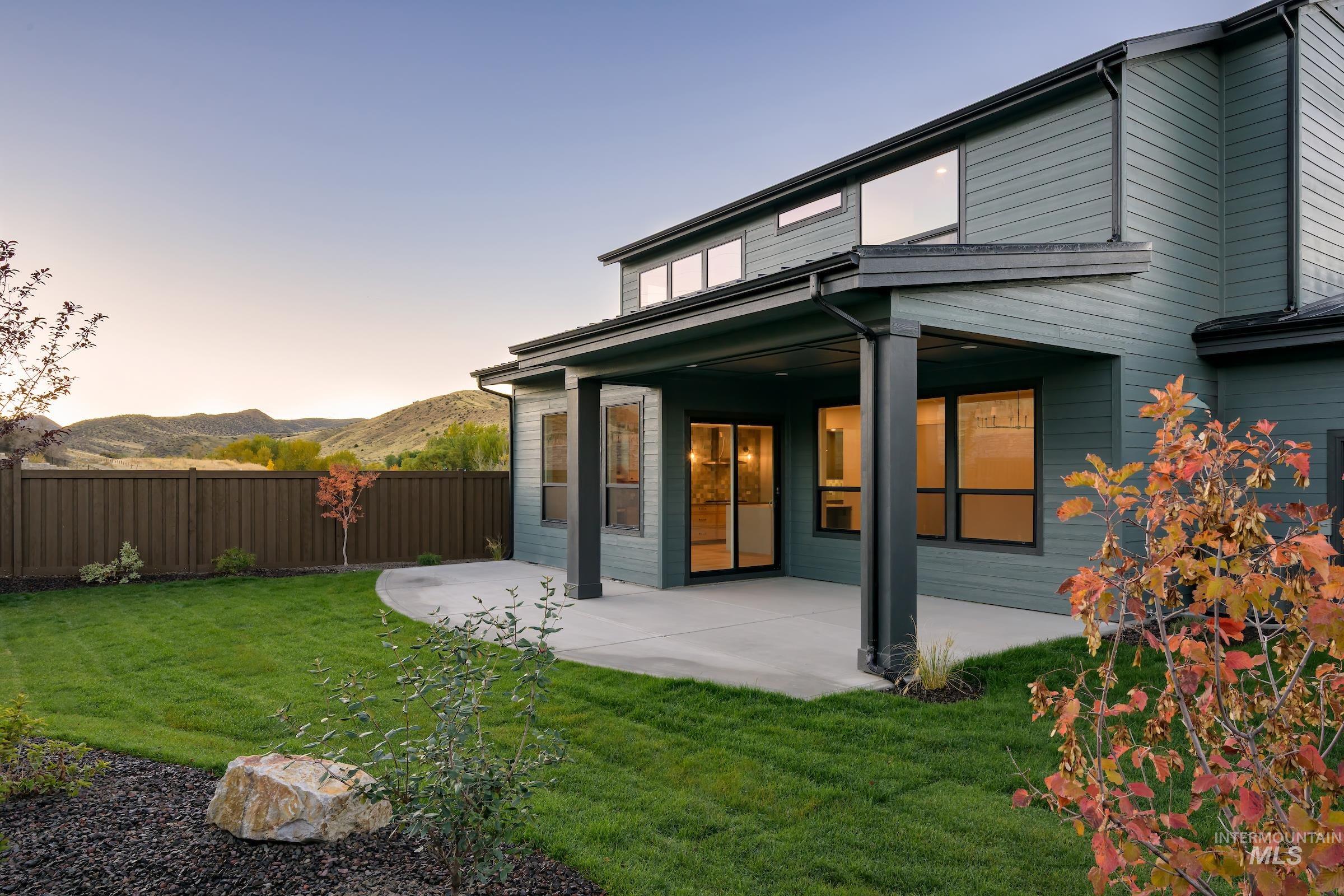 Back of property featuring a patio area and a mountain view
