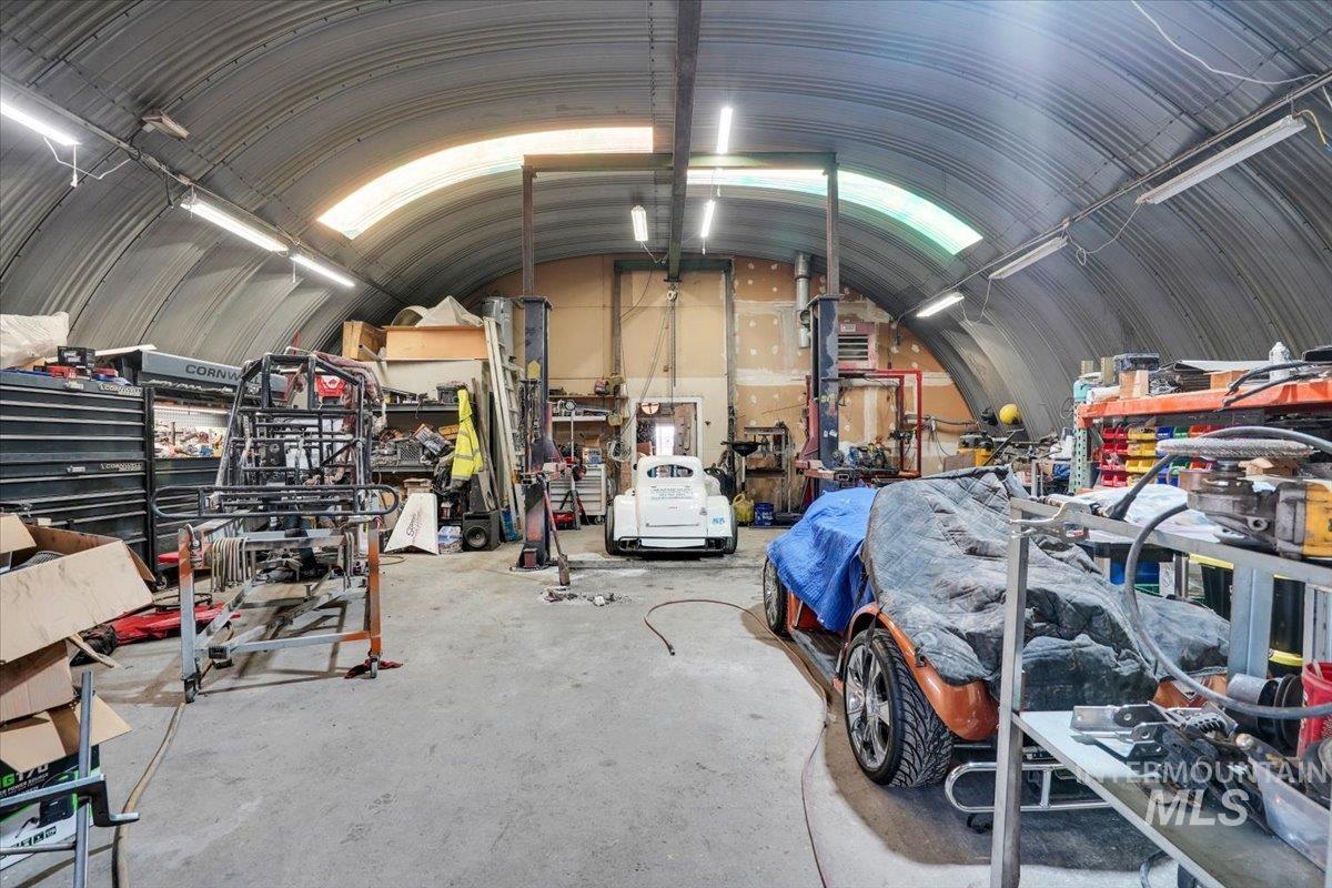 Garage featuring a workshop area and metal wall