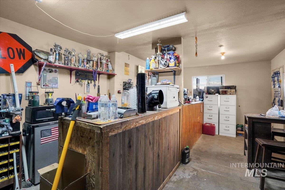 Misc room with concrete floors and a textured ceiling