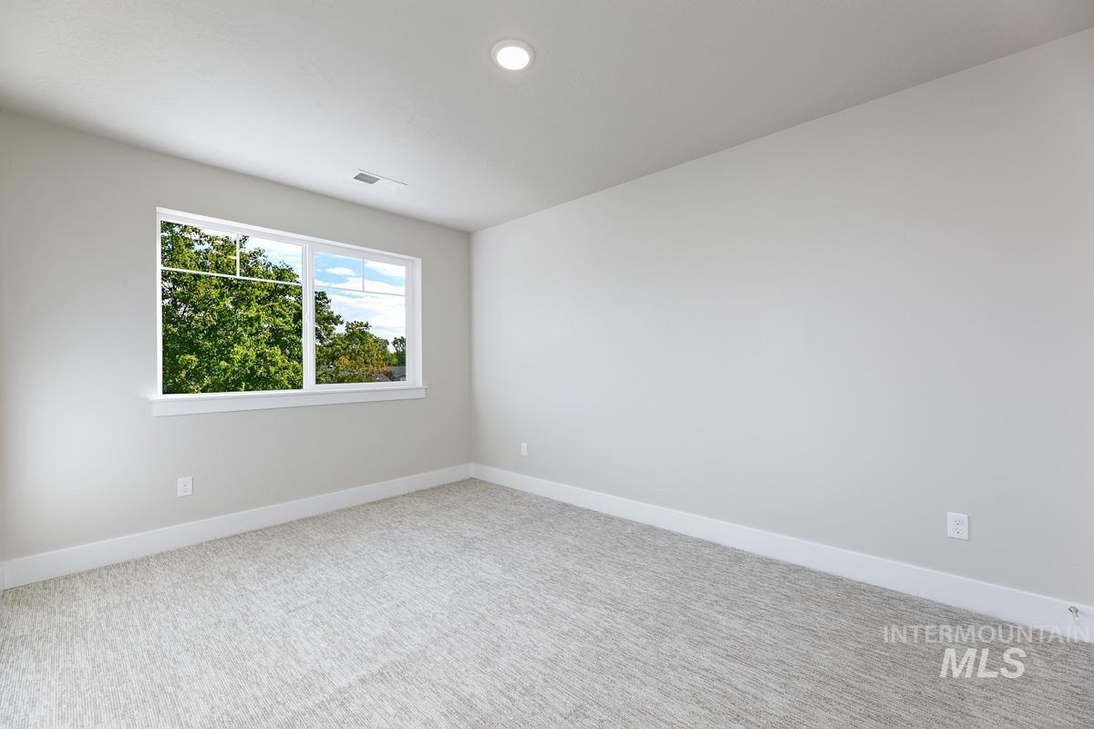 Spare room featuring carpet floors and recessed lighting