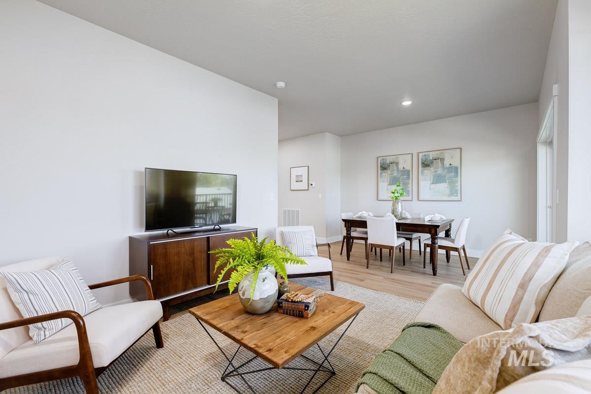 Living area with wood finished floors and baseboards