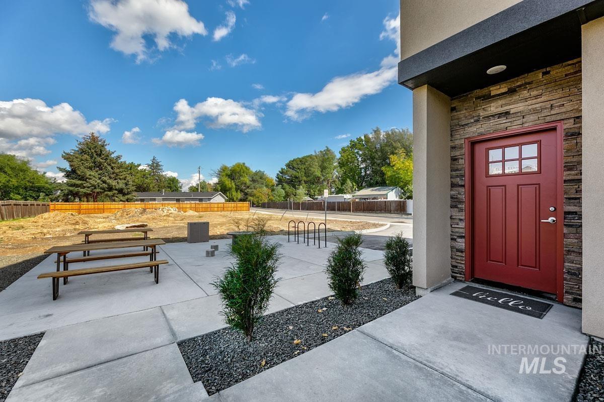 Doorway to property featuring stone siding and stucco siding