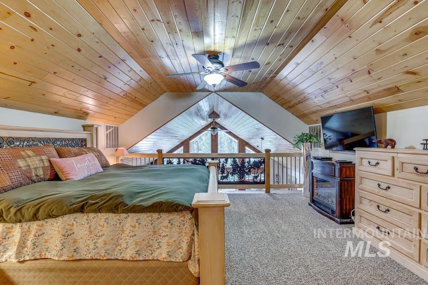 Carpeted bedroom featuring wooden ceiling and lofted ceiling