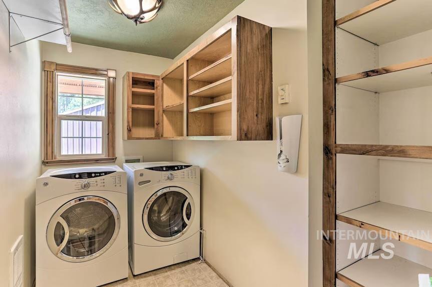 Laundry room with washer and dryer and cabinet space