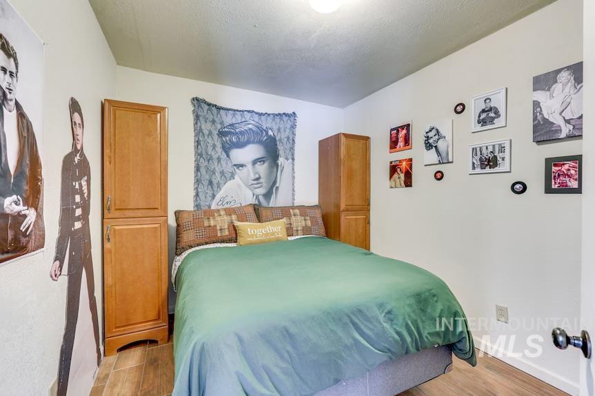 Bedroom with light wood finished floors and baseboards