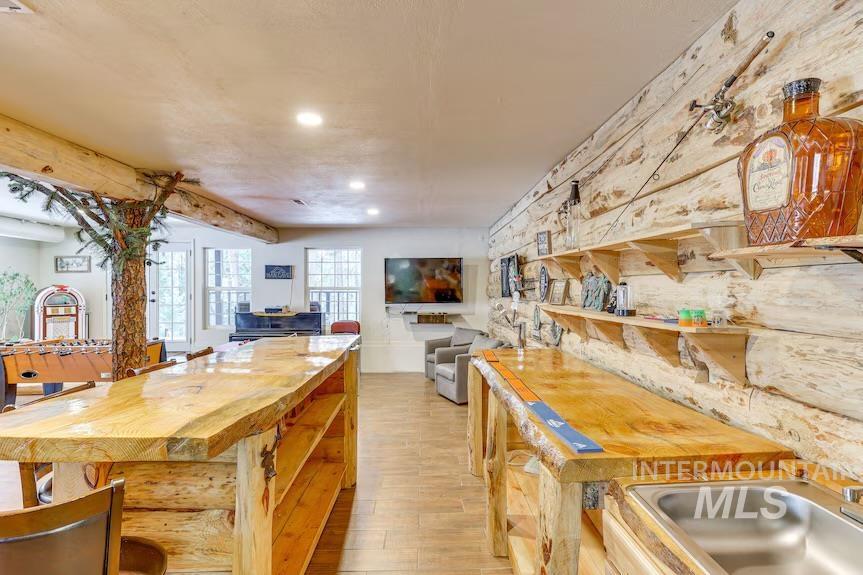 Kitchen featuring light wood-style flooring, recessed lighting, and open floor plan